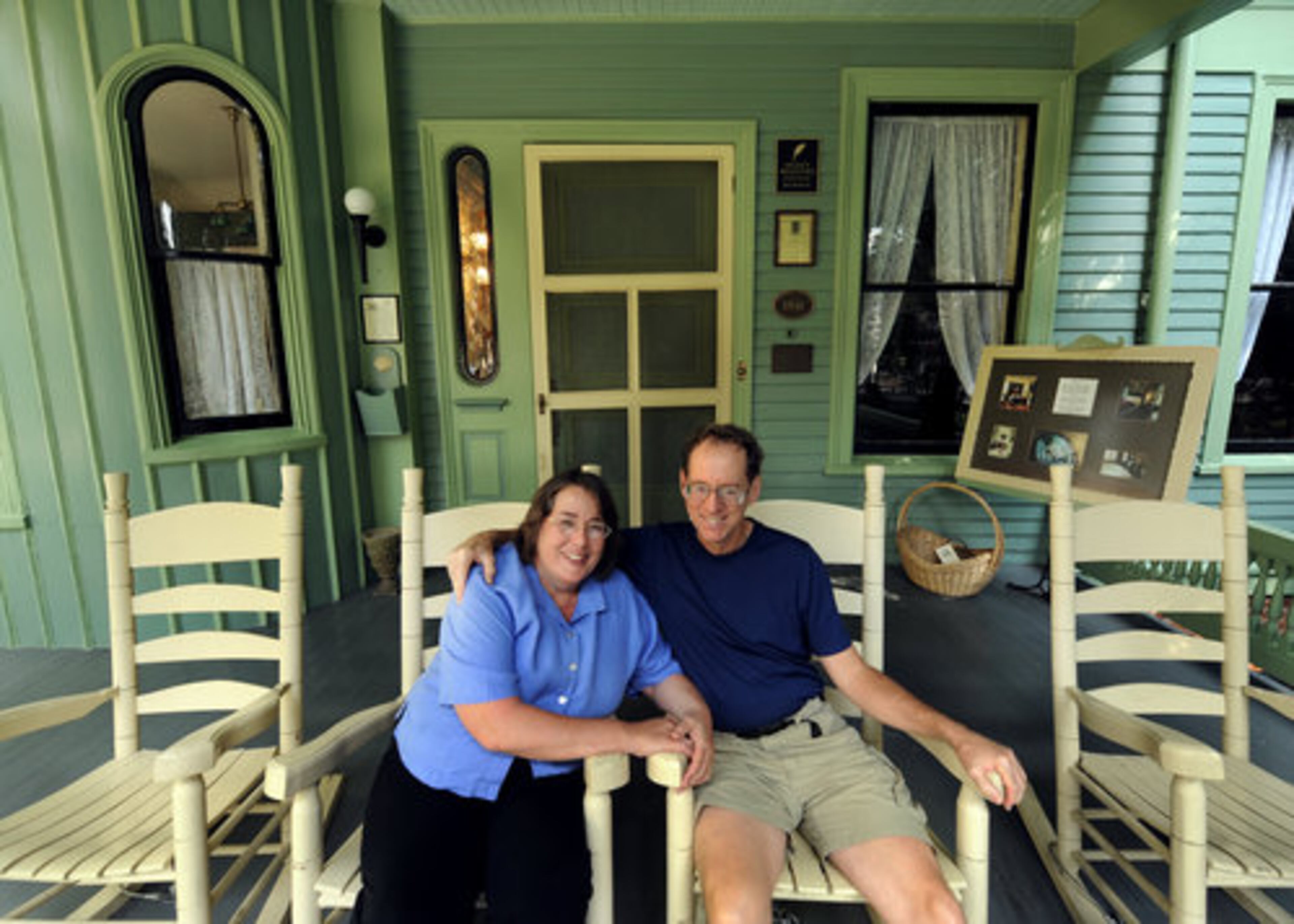 Debbie and Ed McCord sit on the front porch. The house became the catalyst for a new stage in the McCords' lives, one where they would leave their corporate jobs to engage in the ultimate work-at-home occupation, running a bed-and-breakfast.