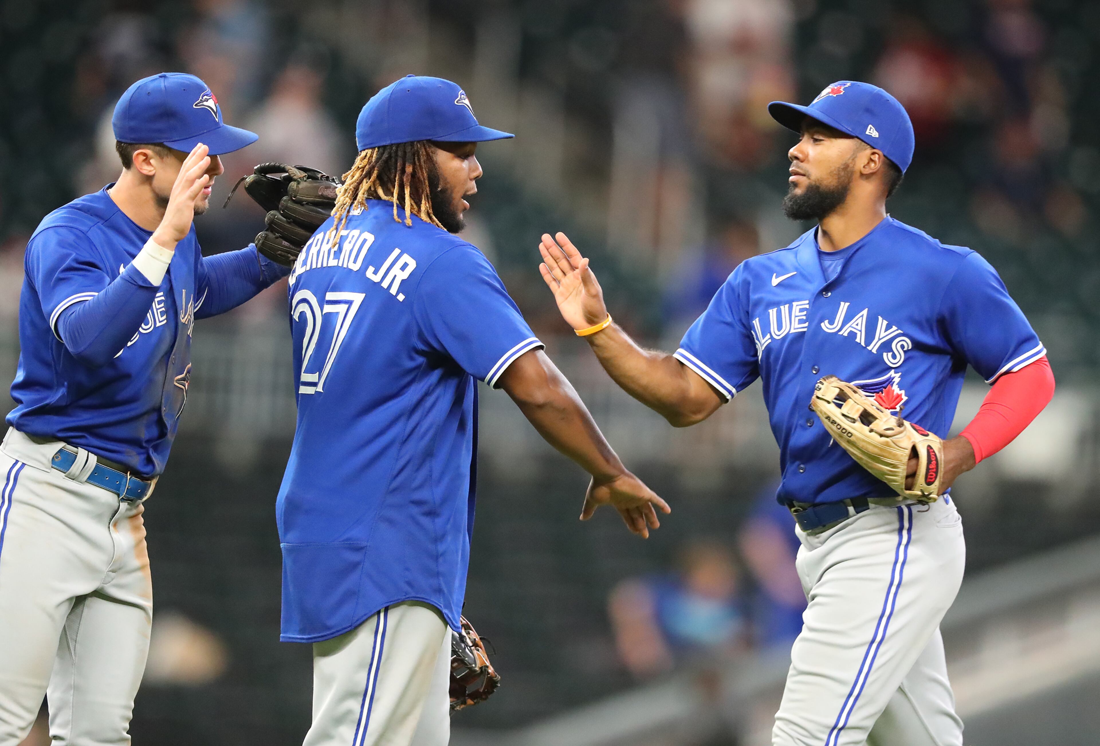Blue Jays Vladimir Guerrero Jr. (center) and Teoscar Hernandez (right) celebrate a 5-3 victory over the Atlanta Braves. “Curtis Compton / Curtis.Compton@ajc.com”