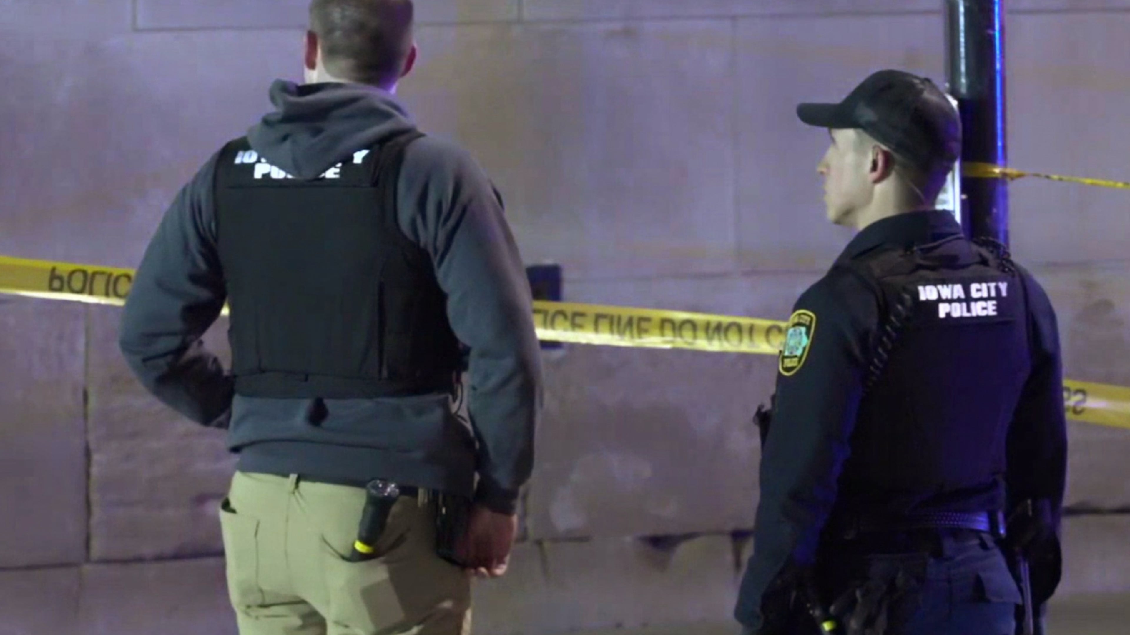 This image made from video provided by KCRG shows Iowa City police officers working the scene of a downtown shooting near the University of Iowa campus on Sunday, April 19, 2026. (KCRG via AP)
