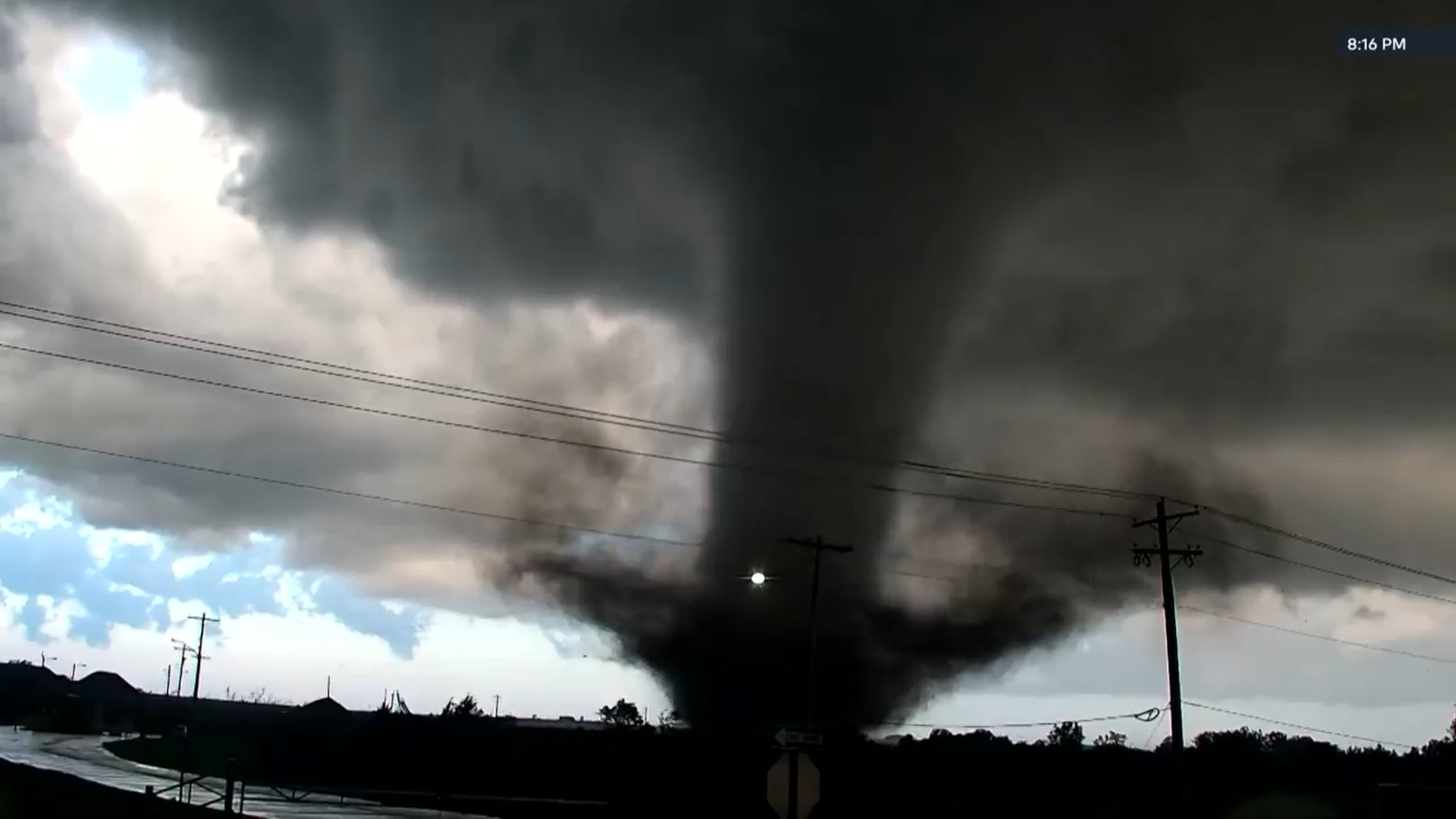 In this image taken from video from KWTV/KOTV, a tornado crosses a highway in Enid, Okla., Thursday, April 23, 2026. (KWTV/KOTV via AP)