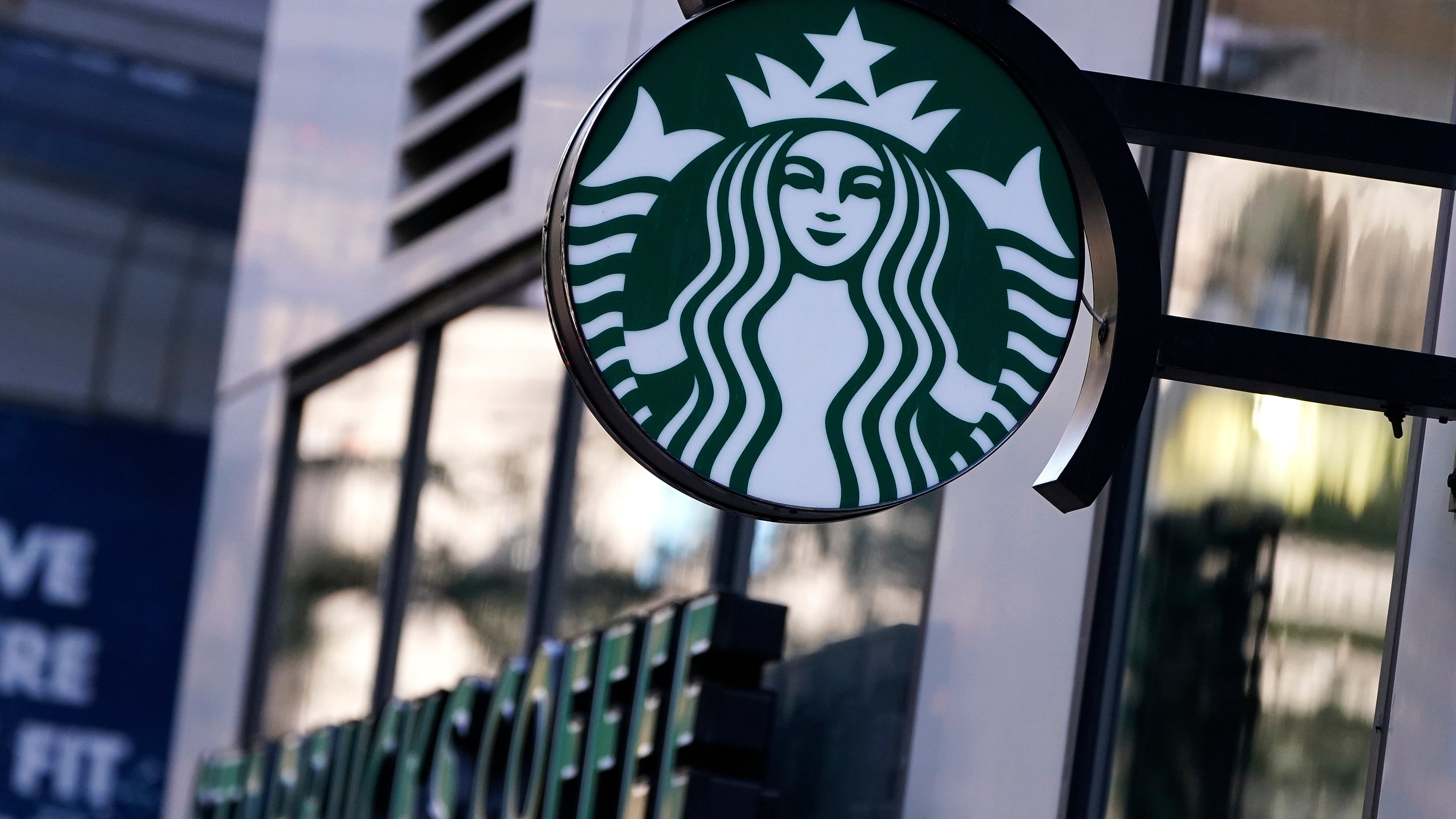 FILE - The "Siren" logo hangs outside a Starbucks Coffee shop, Wednesday, July 14, 2021, in Boston. (AP Photo/Charles Krupa, File)