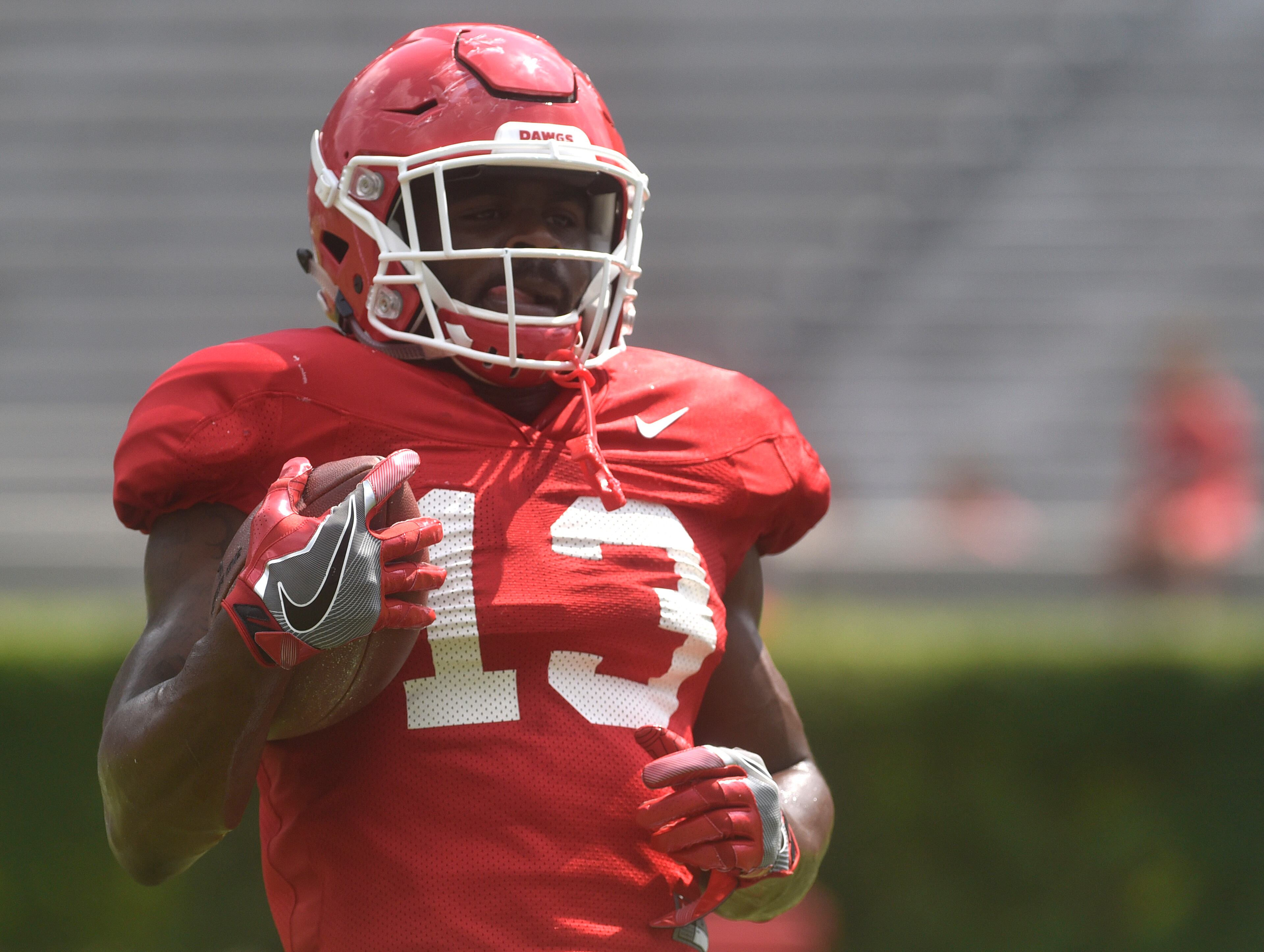 Georgia running back Elijah Holyfield (13) runs a drill at an open practice during the annual UGA Fan Day at Sanford Stadium on Saturday, Aug 5, 2017 in Athens, Ga.
(RICHARD HAMM)