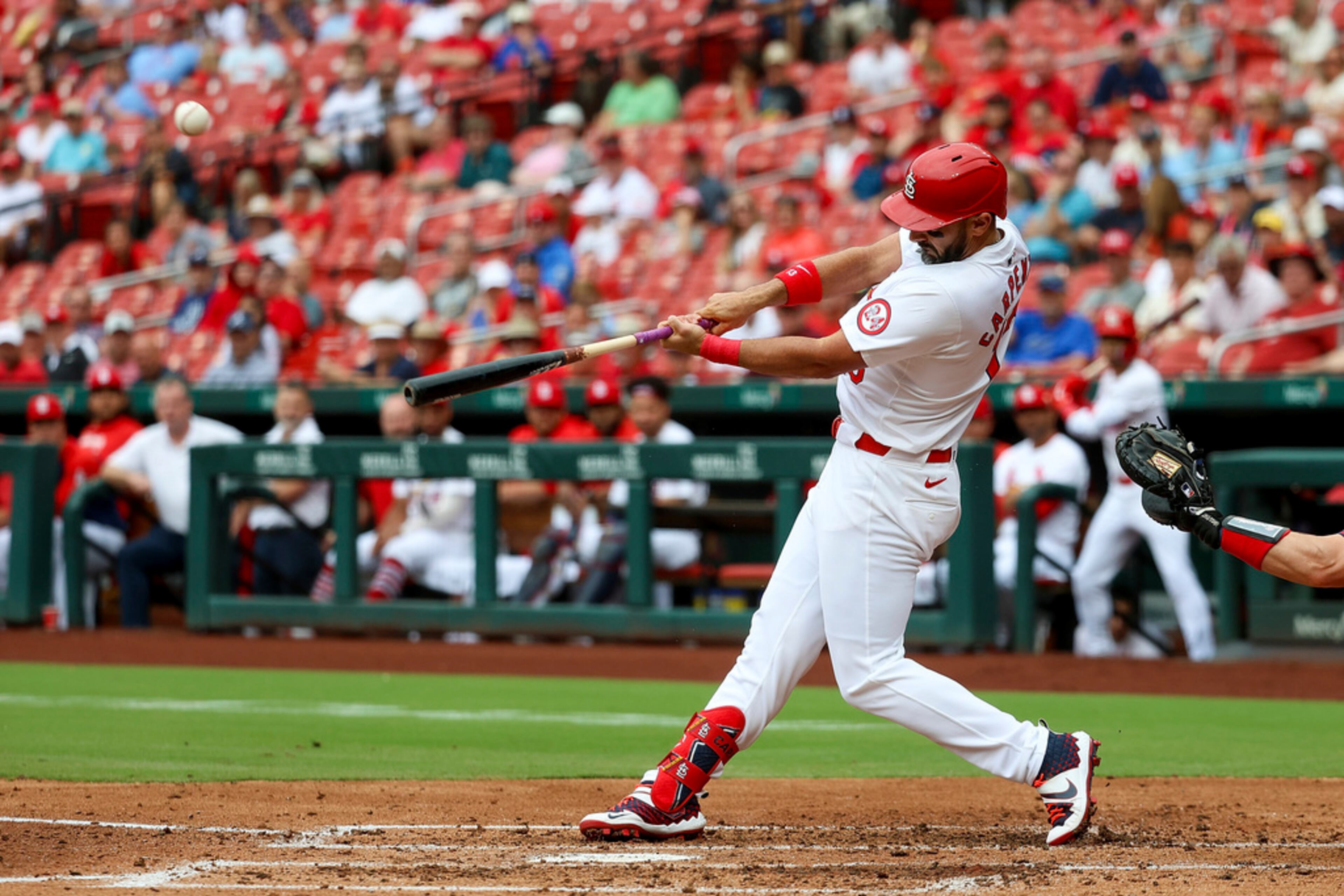 St. Louis Cardinals' Matt Carpenter hits a sacrifice fly during the second inning in the first game of a baseball doubleheader against the Atlanta Braves Wednesday, June 26, 2024, in St. Louis. (AP Photo/Scott Kane)