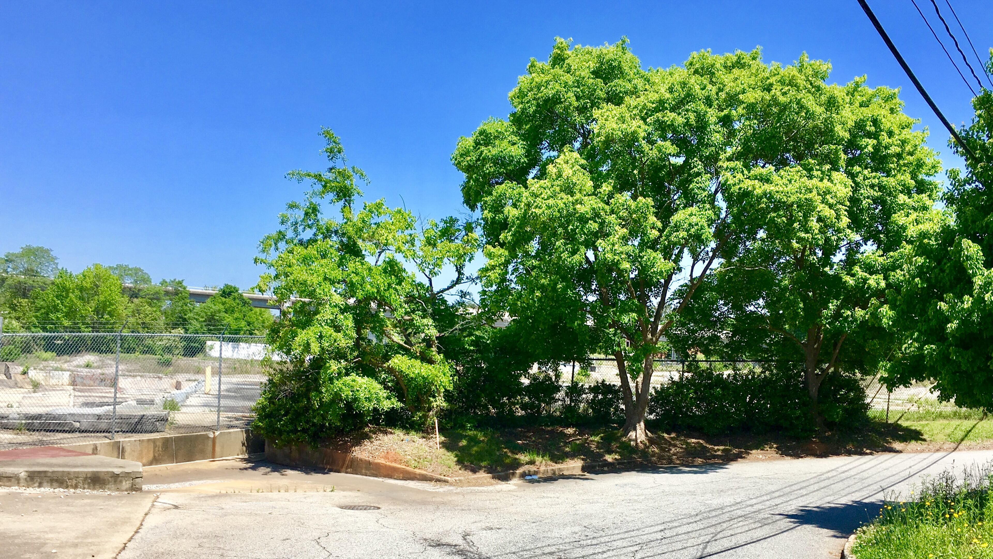 Parry Street (right) and Center Street (foreground) dead end at this spot, just south of the old Fenner Dunlop mill site. Avondale Estates’ commission has indicted the possibility of extending these roads, among others, to complete the city’s street grid. Doing so may require seizing property through eminent domain. Bill Banks for the AJC