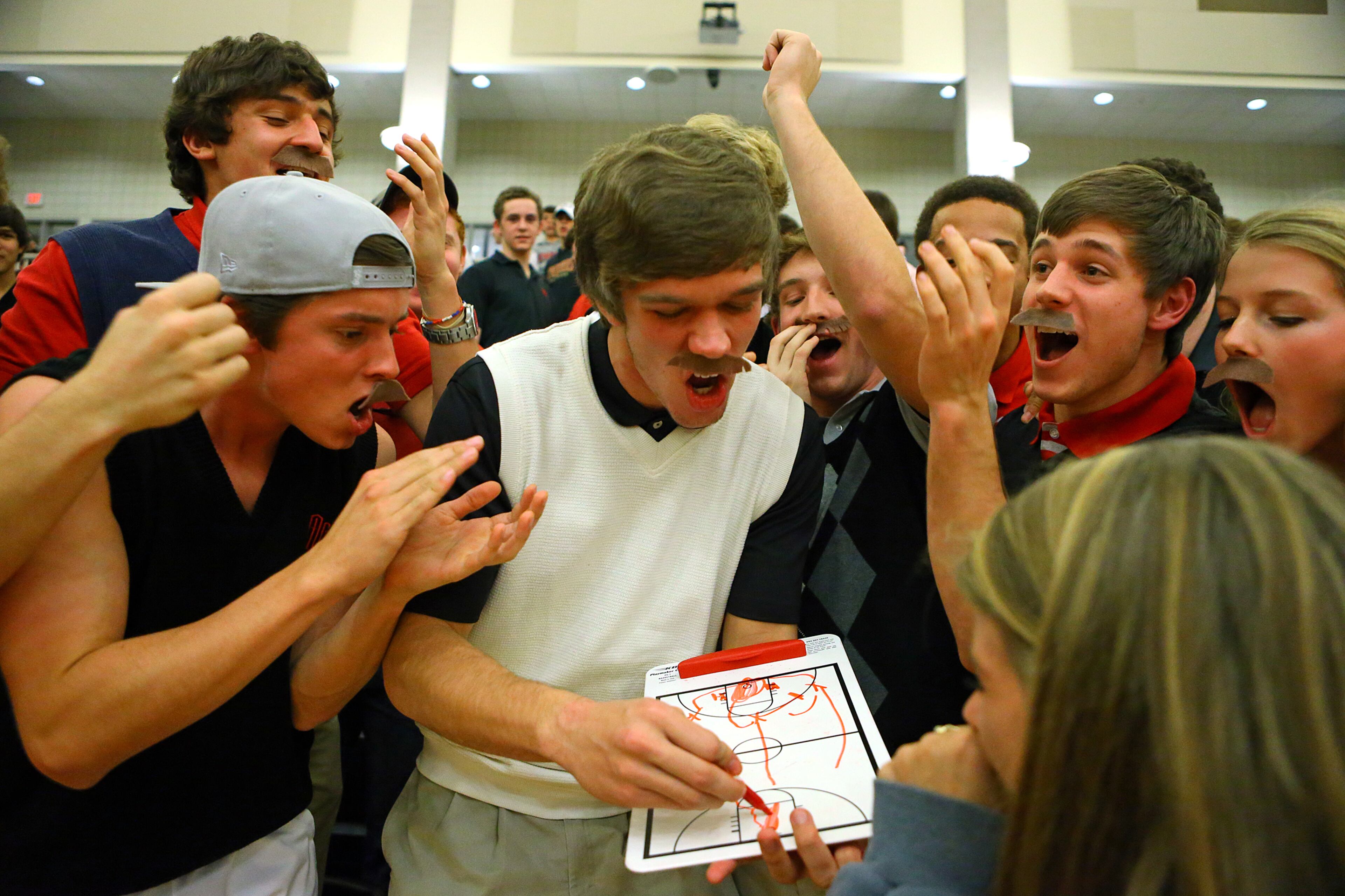 GAC fans sport mustaches in honor of their head coach Eddie Martin during the first half of their high school basketball game against Westminster at Greater Atlanta Christian High School on Tuesday, Jan. 14, 2014, in Norcross.