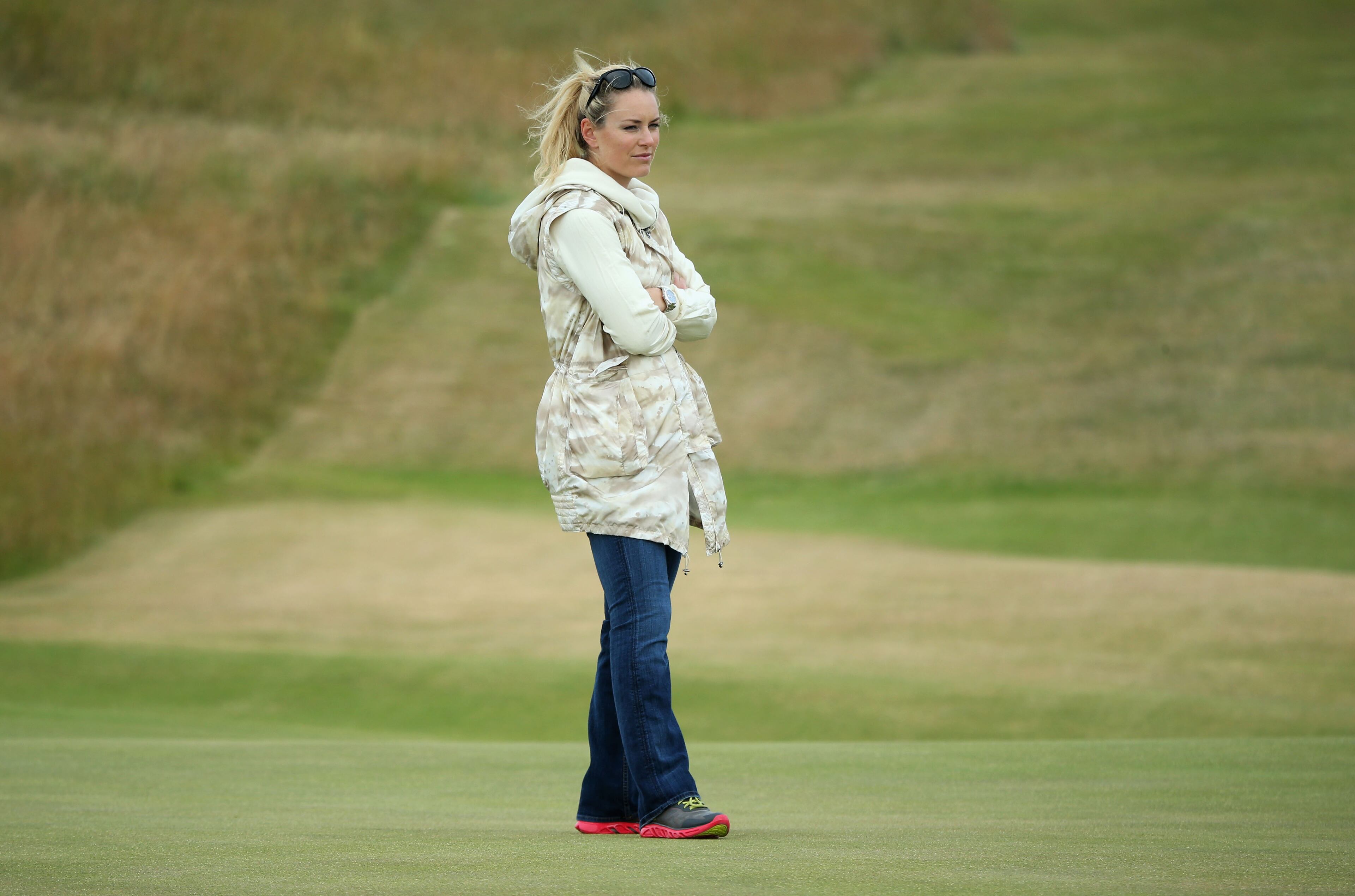 Skier Lindsey Vonn watches Tiger Woods of the United States ahead of the 142nd Open Championship at Muirfield on July 15, 2013 in Gullane, Scotland. (Photo by Andy Lyons/Getty Images)