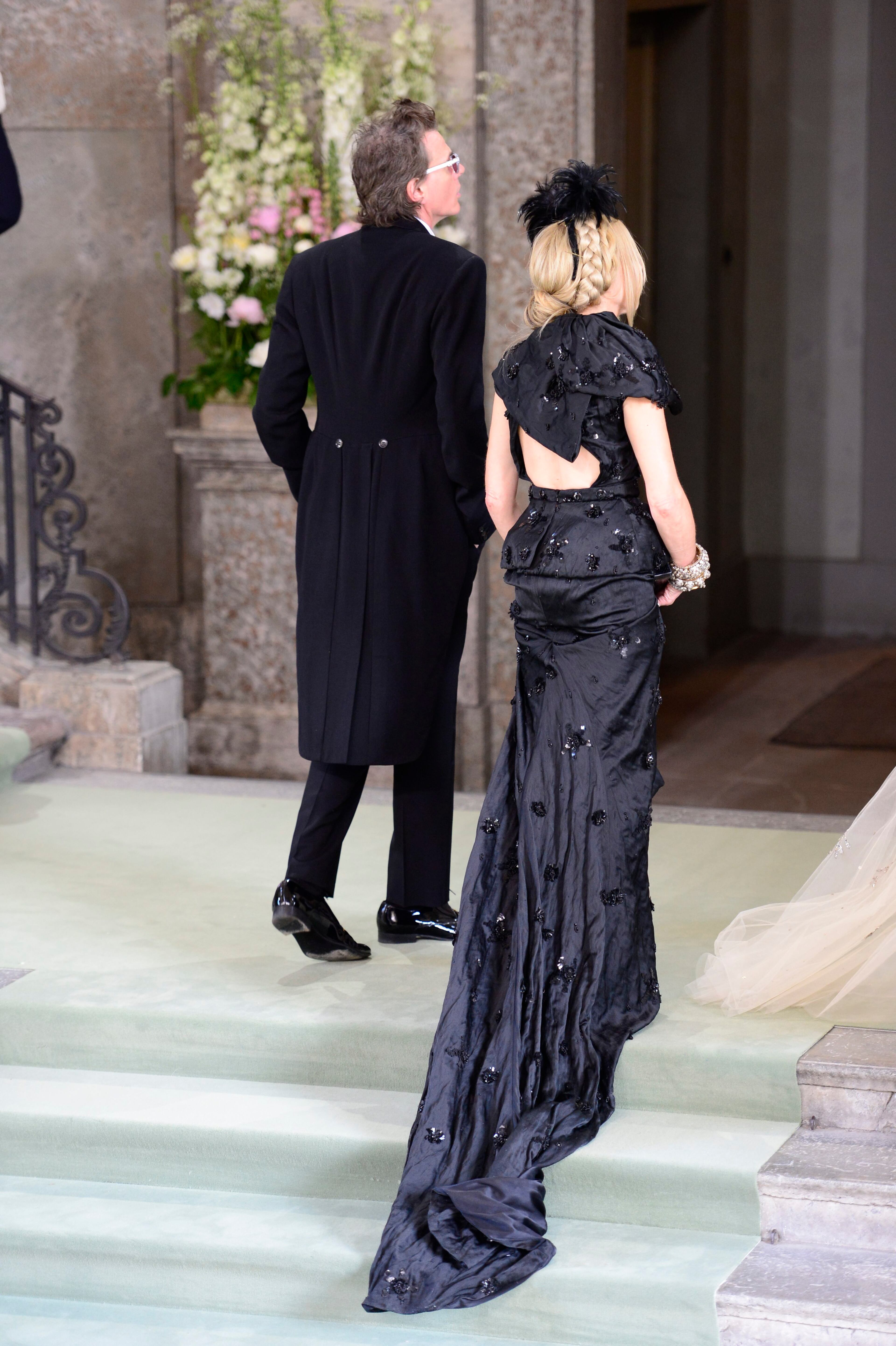 John Taylor of the music group Duran Duran and his wife Gela Nash arrive at the Royal Chapel for the wedding of Sweden's Princess Madeleine and Christopher O'Neill, in Stockholm, Saturday June 8, 2013. (AP Photo/Soren Andersson)