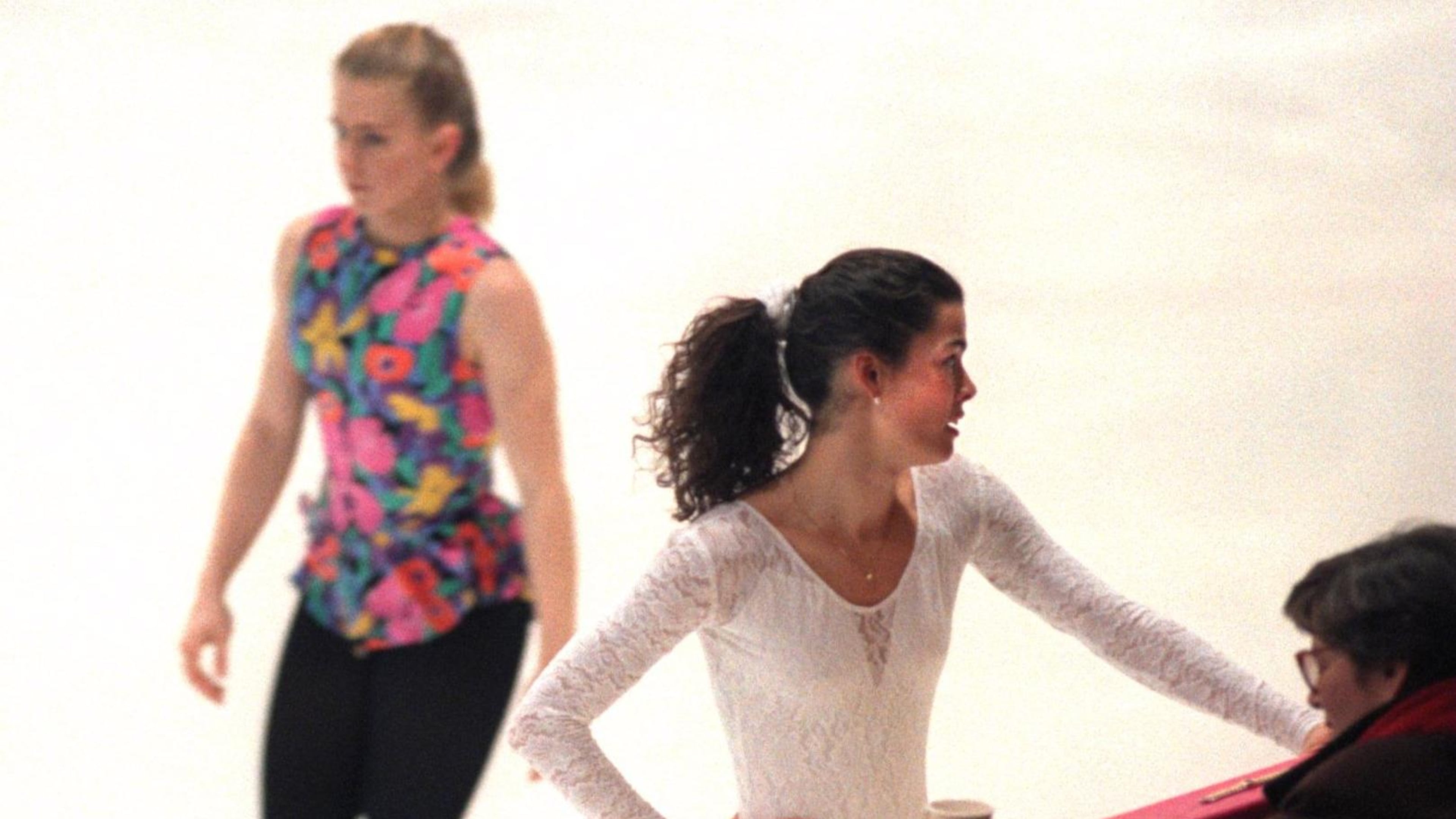 Former Olympic figure skater Tonya Harding skates by teammate Nancy Kerrigan during a pratice at the 1994 Olympics in Lillehammer, Norway.