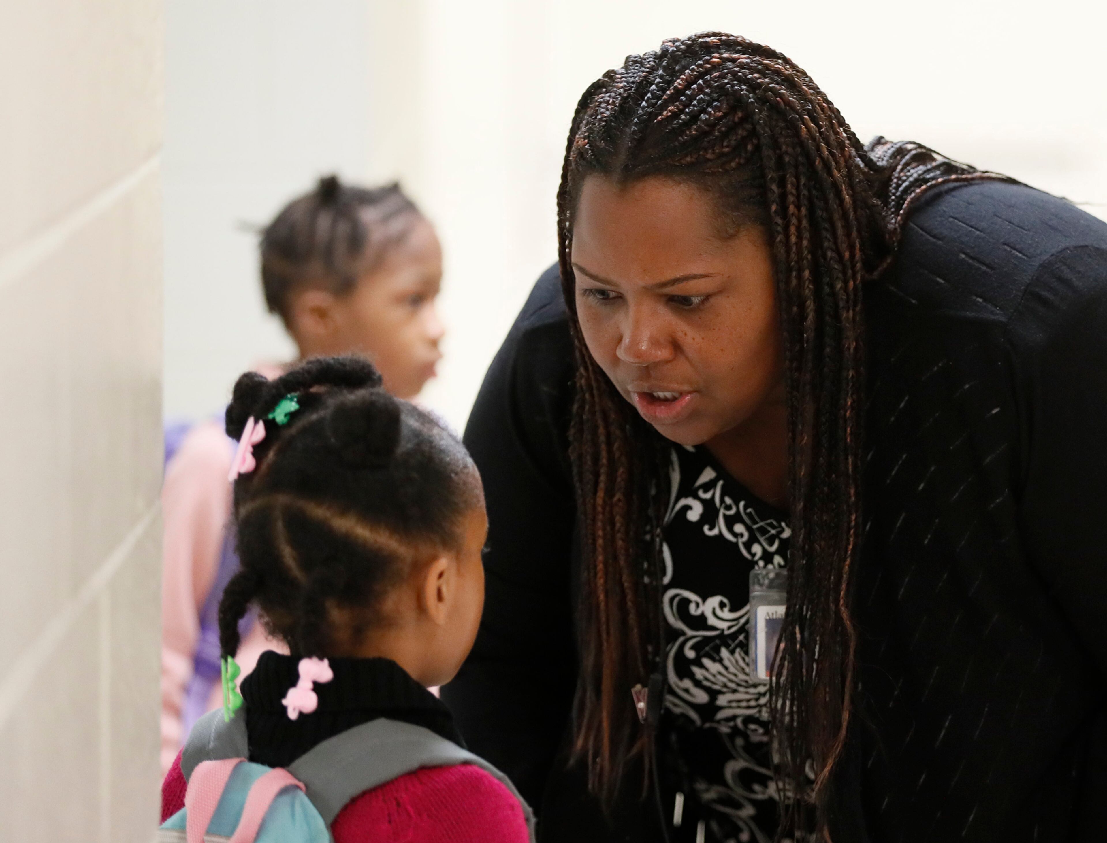 Dr. Taylor talks to a child before school starts on Oct. 24, 2019. Bob Andres / robert.andres@ajc.com