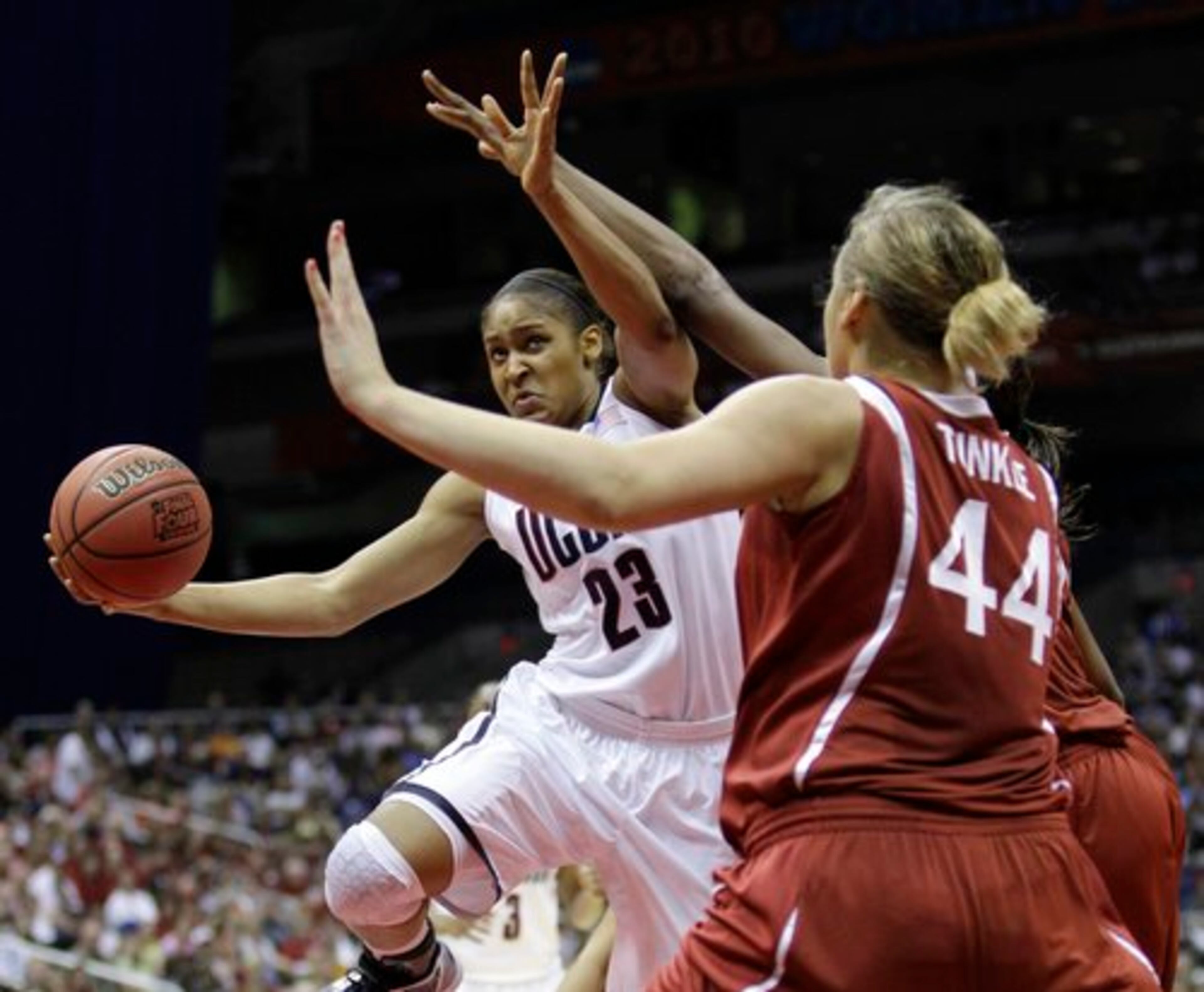 Connecticut's Maya Moore (23) attempts a shot as Stanford's Joslyn Tinkle (44) defends in the first half of the women's NCAA Final Four college basketball championship game Tuesday, April 6, 2010, in San Antonio.