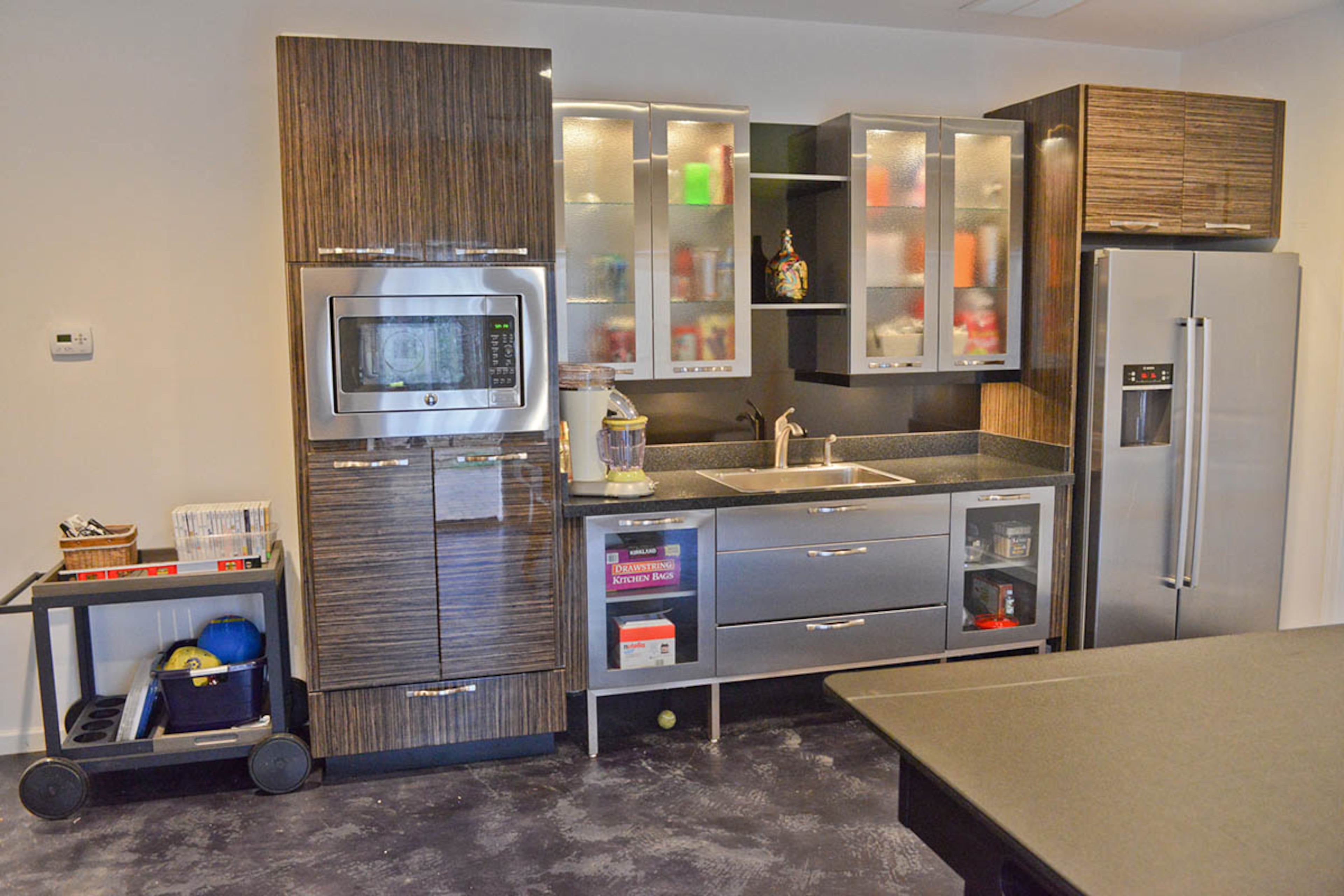 Grifenhagen Zhiss found discounted kitchen cabinetry and appliances, which were previously in a Buckhead showroom, through SR Appliance Depot. Although they were not assembled and came from separate collections, Jesse Rumsey Cabinets helped her design and install the kitchen in the full finished basement. In the kitchen are snacks for the kids, her lunch and even casseroles for dinner to heat up when the boys are playing in the backyard.