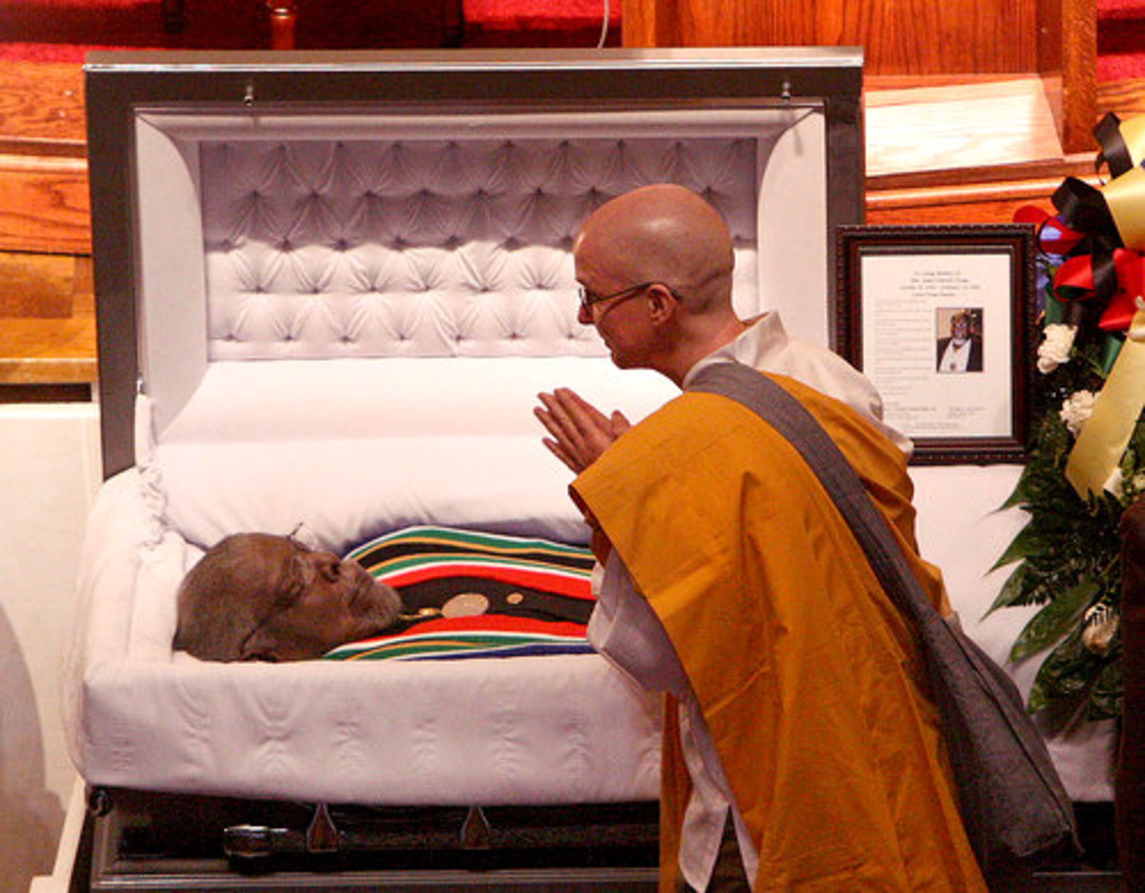 Buddist Denise Laffan pays her respect to Civil Rights leader Rev. James Orange.