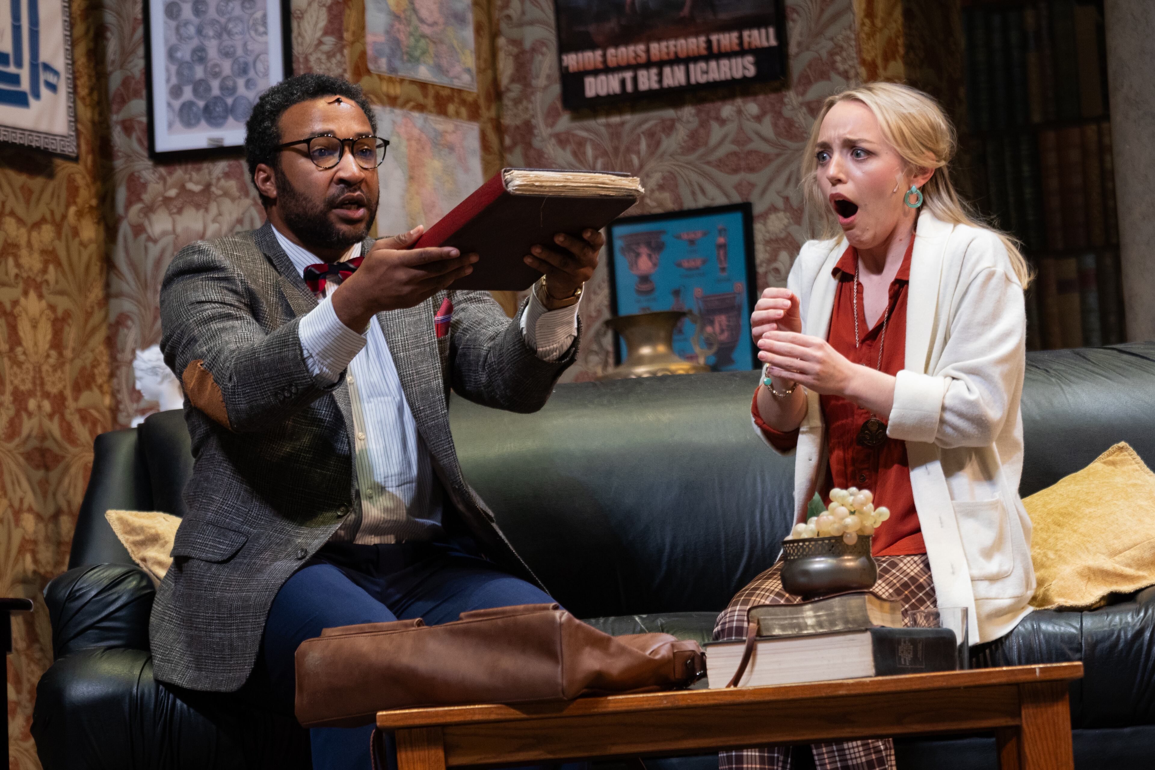 Christopher Hampton holds his discovery, a priceless manuscript, which his academic colleague, played by Alexandra Ficken, finds thrilling.