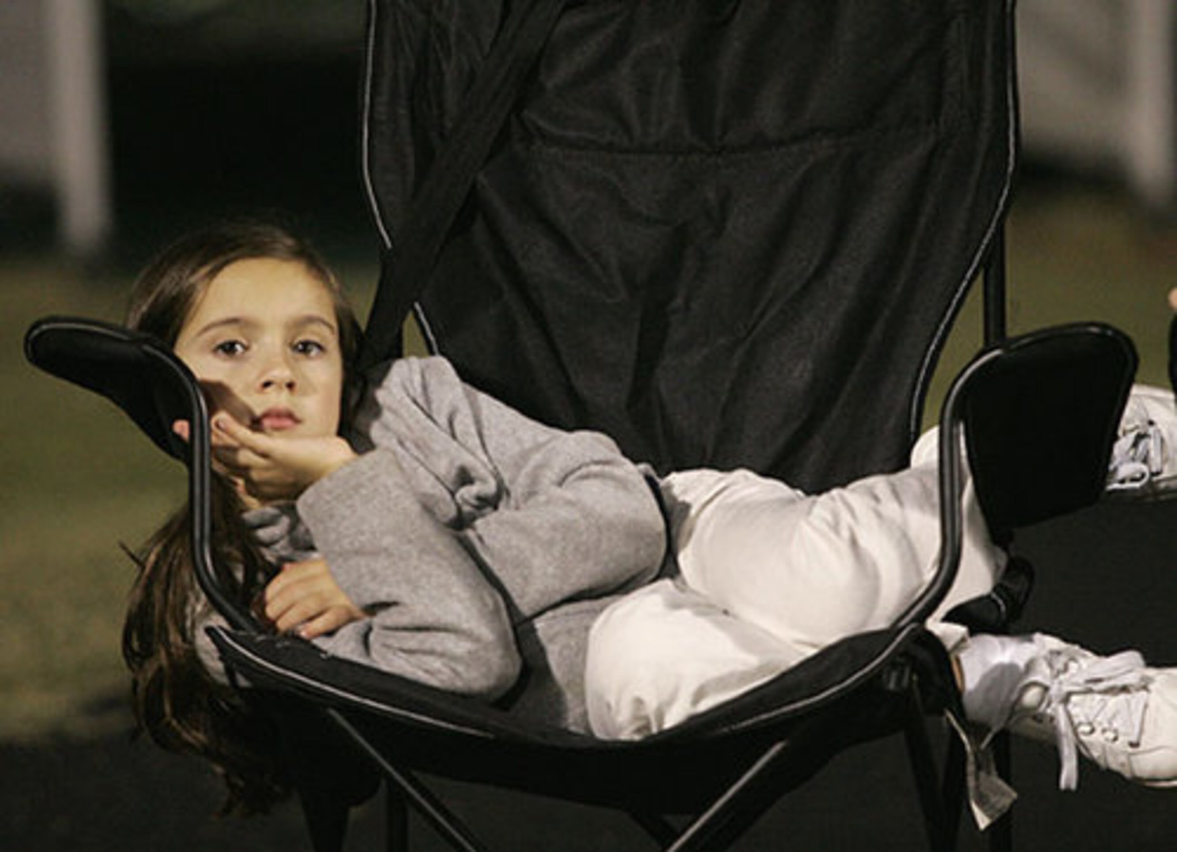 Seven-year old Kelly Burnette, whose father is offensive coordinator for South Gwinnett, finds a comfy chair to watch all the action.
