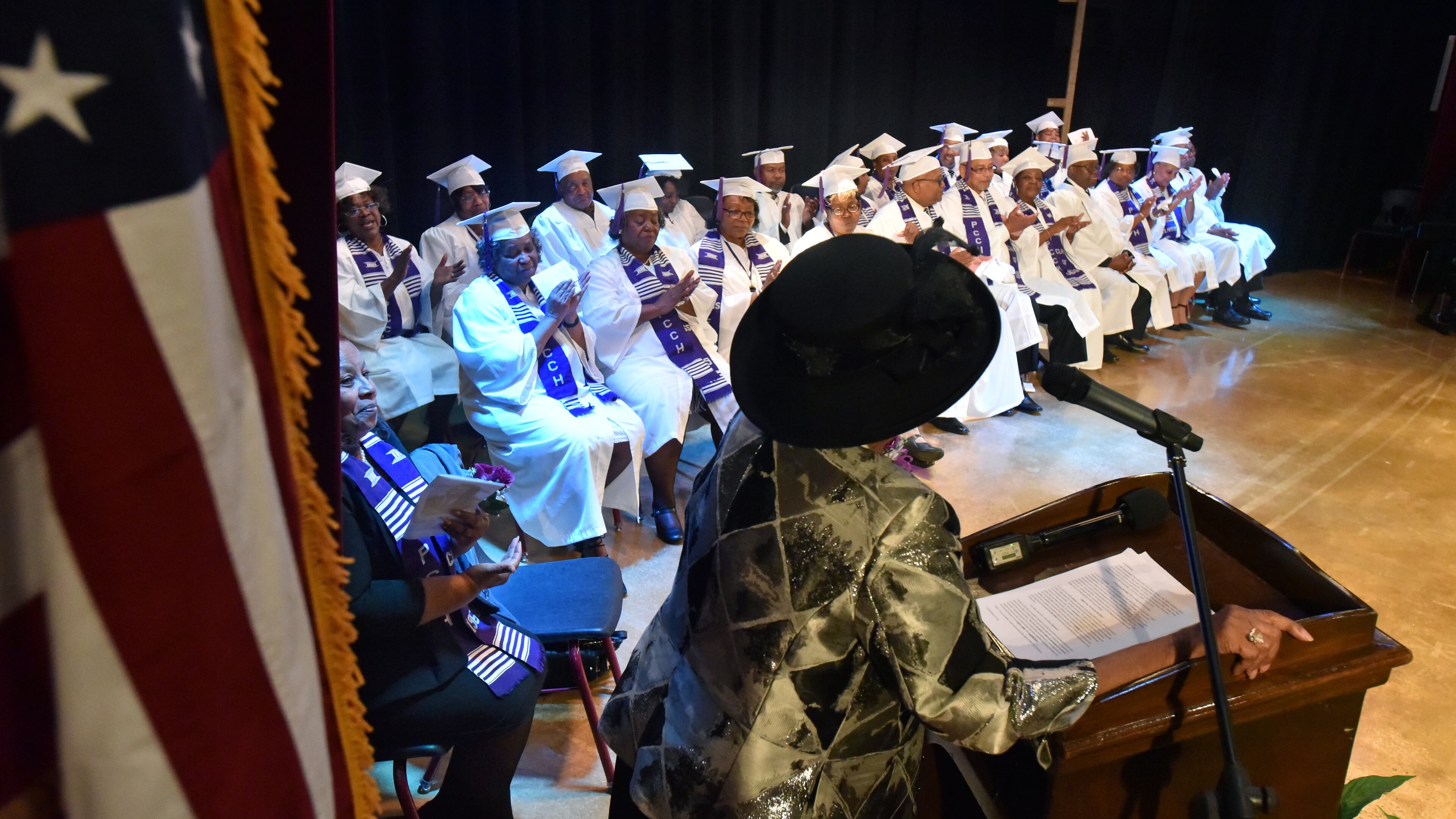 March 3, 2018 Zebulon - Graduates from the Class of 1969 applaud as their former teacher Geneva Woods (foreground) speaks during the graduation ceremony, nearly 50 years after their last days of school at Pike County Consolidated High School, at the Pike County Auditorium in Zebulon on Saturday, March 3, 2018. Forty-nine years ago, the students at Pike County Consolidated High School, an all-black institution, emptied into the street to protest the way desegregation was being handled in their community. By way of punishment, the entire Class of 1969 was barred from graduation. All seniors were refused diplomas. This Saturday, graduates from the Class of 1969 were finally honored with a graduation ceremony nearly 50 years after their last days of school at Pike County Consolidated High School in Concord. HYOSUB SHIN / HSHIN@AJC.COM