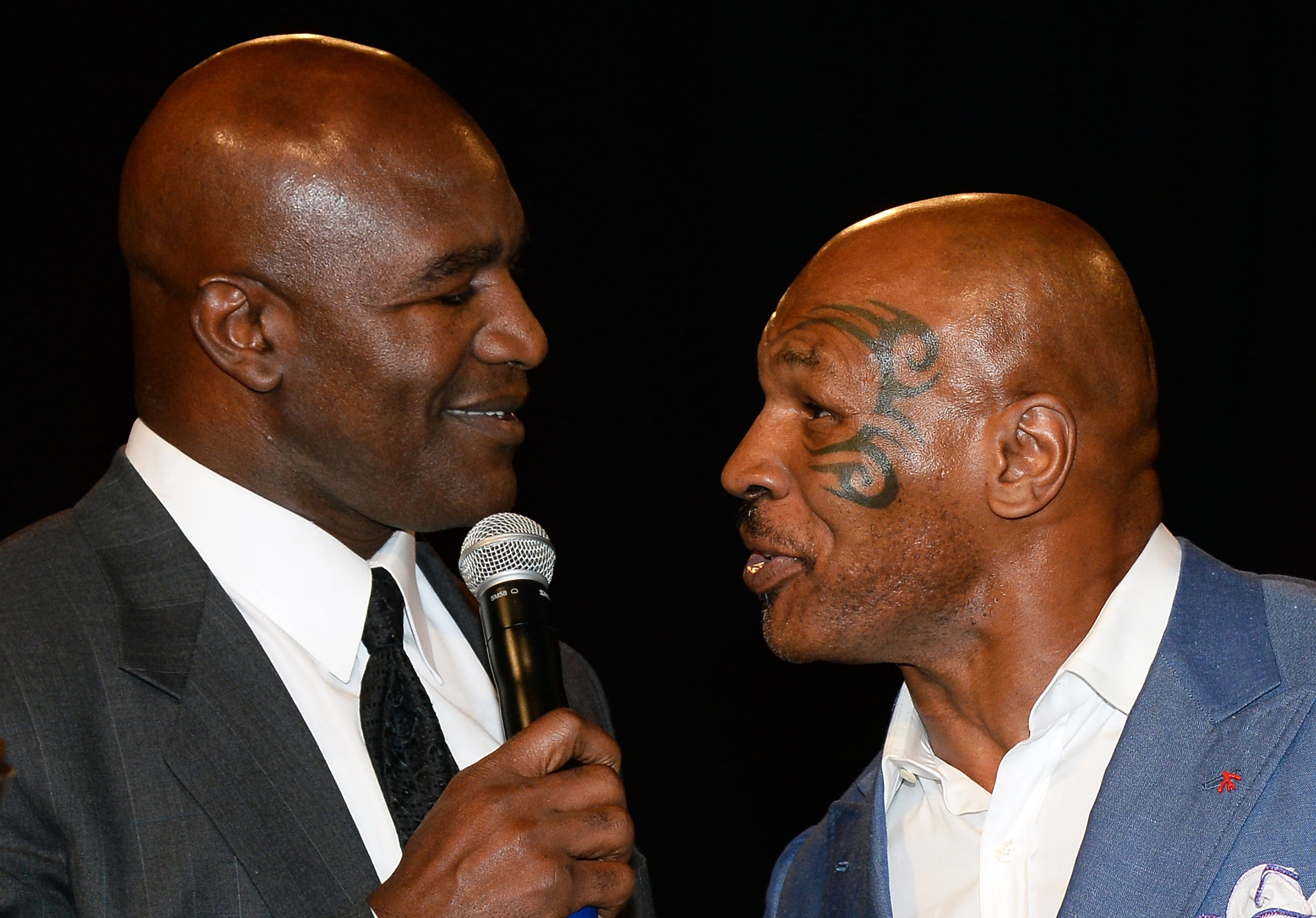 LAS VEGAS, NV - AUGUST 09: Former boxer Evander Holyfield (L) is inducted into the Nevada Boxing Hall of Fame by former boxer Mike Tyson at the second annual induction gala at the New Tropicana Las Vegas on August 9, 2014 in Las Vegas, Nevada. (Photo by Ethan Miller/Getty Images)