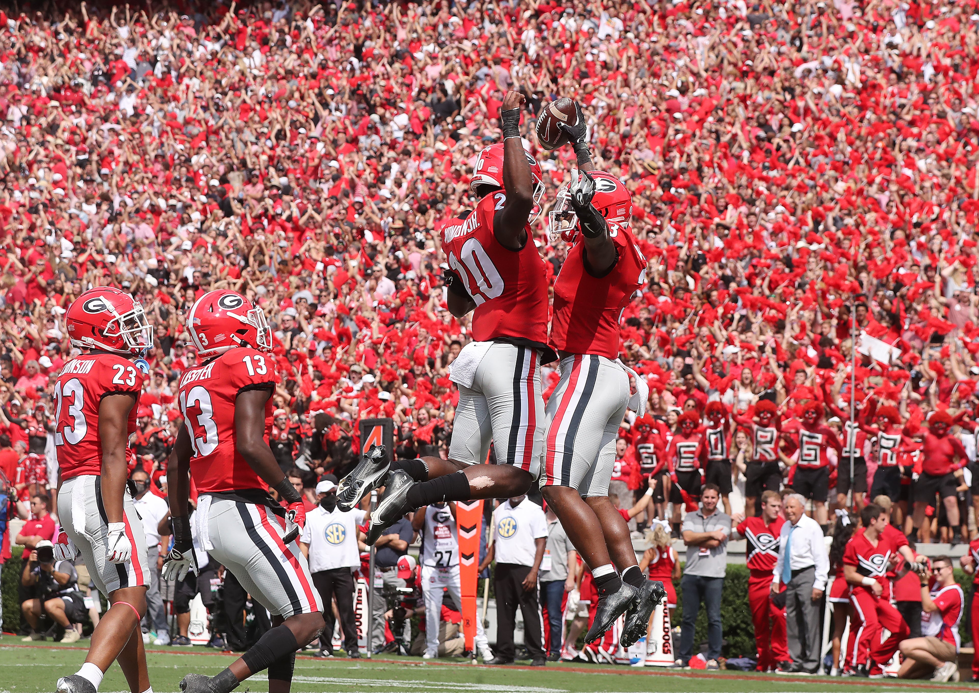100221 ATHENS: Georgia tailback Zamir White (right) celebrates recovering a blocked punt against Arkansas in the endzone for a special teams touchdown and a 21-0 lead with Smael Mondon Jr. (left) during the first quarter in a NCAA college football game on Saturday, Oct. 2, 2021, in Athens. “Curtis Compton / Curtis.Compton@ajc.com”