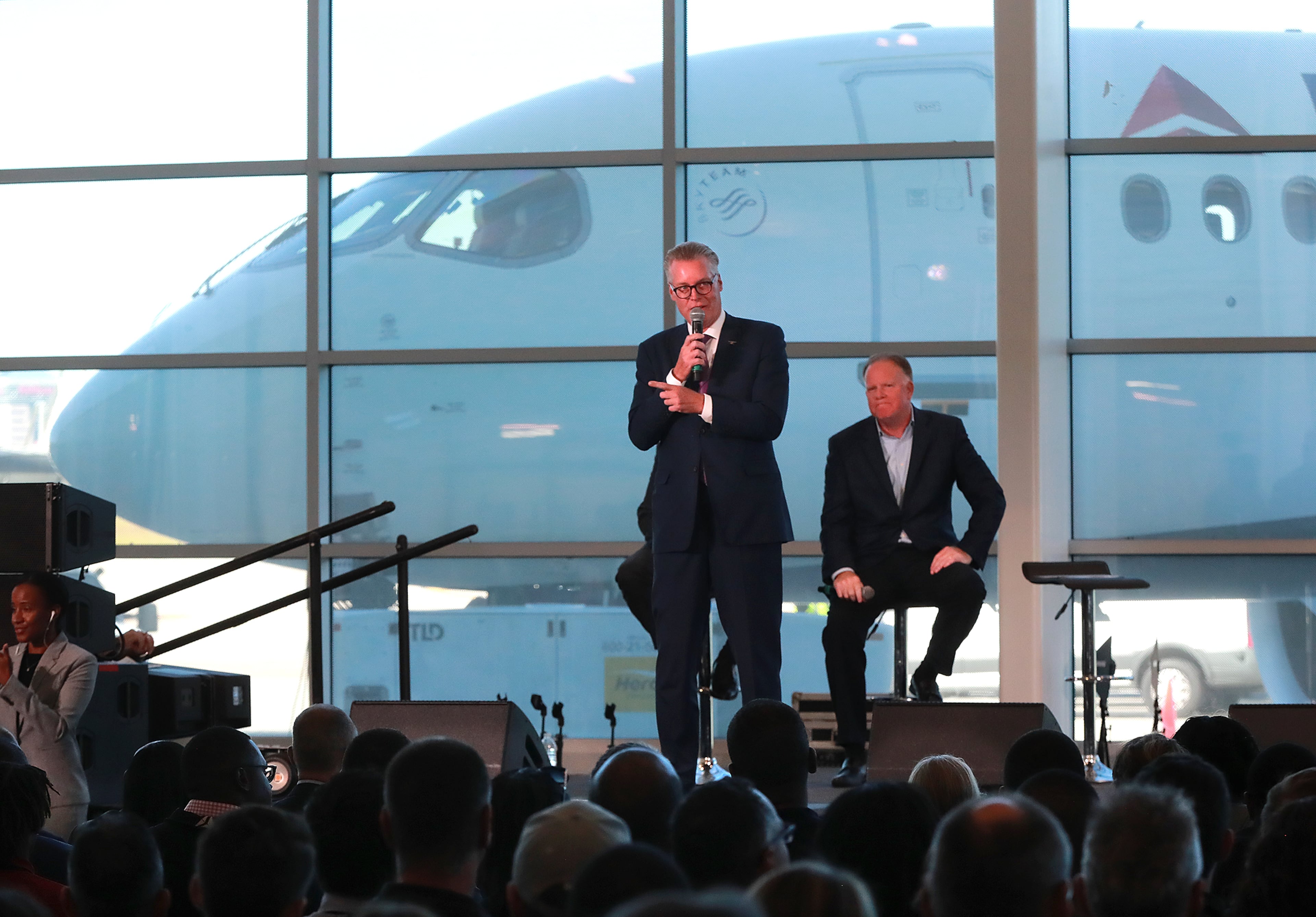 Delta CEO Ed Bastian (left) and COO Gil West unveil the new A220 aircraft while celebrating the 10-year anniversary of merging with Northwest at the Delta Air Lines TechOps on Monday, Oct 29, 2018, in Atlanta. Curtis Compton/ccompton@ajc.com