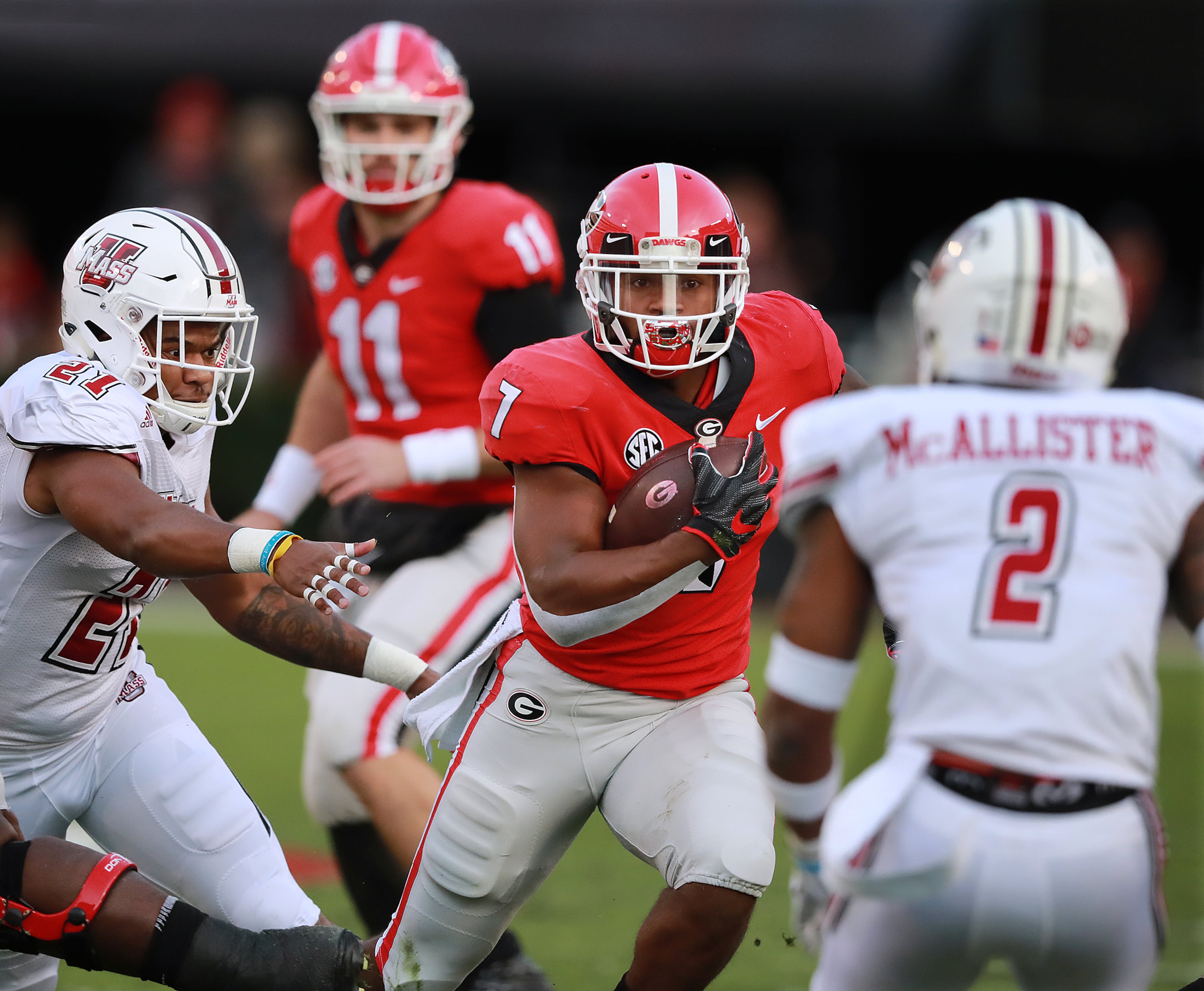 Georgia quarterback Jake Fromm looks on as tailback DeAndre Swift runs for yardage against Massachusetts during the first quarter in a NCAA college football game on Saturday, Nov. 17, 2018, in Athens. Curtis Compton/ccompton@ajc.com