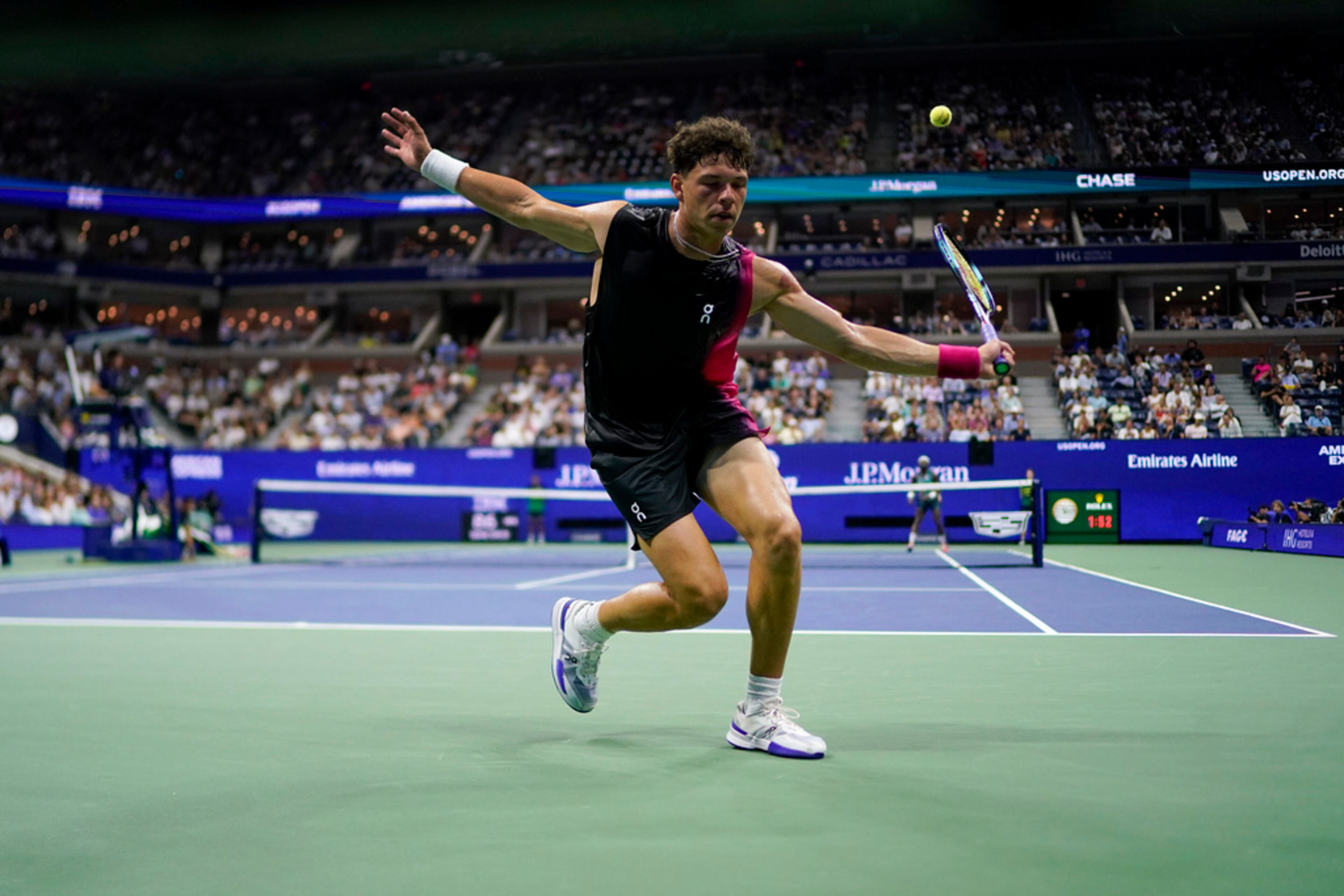 Ben Shelton, of the United States, returns a shot to behind his back to Frances Tiafoe, of the United States, during the quarterfinals of the U.S. Open tennis championships, Tuesday, Sept. 5, 2023, in New York. (AP Photo/Eduardo Munoz Alvarez)