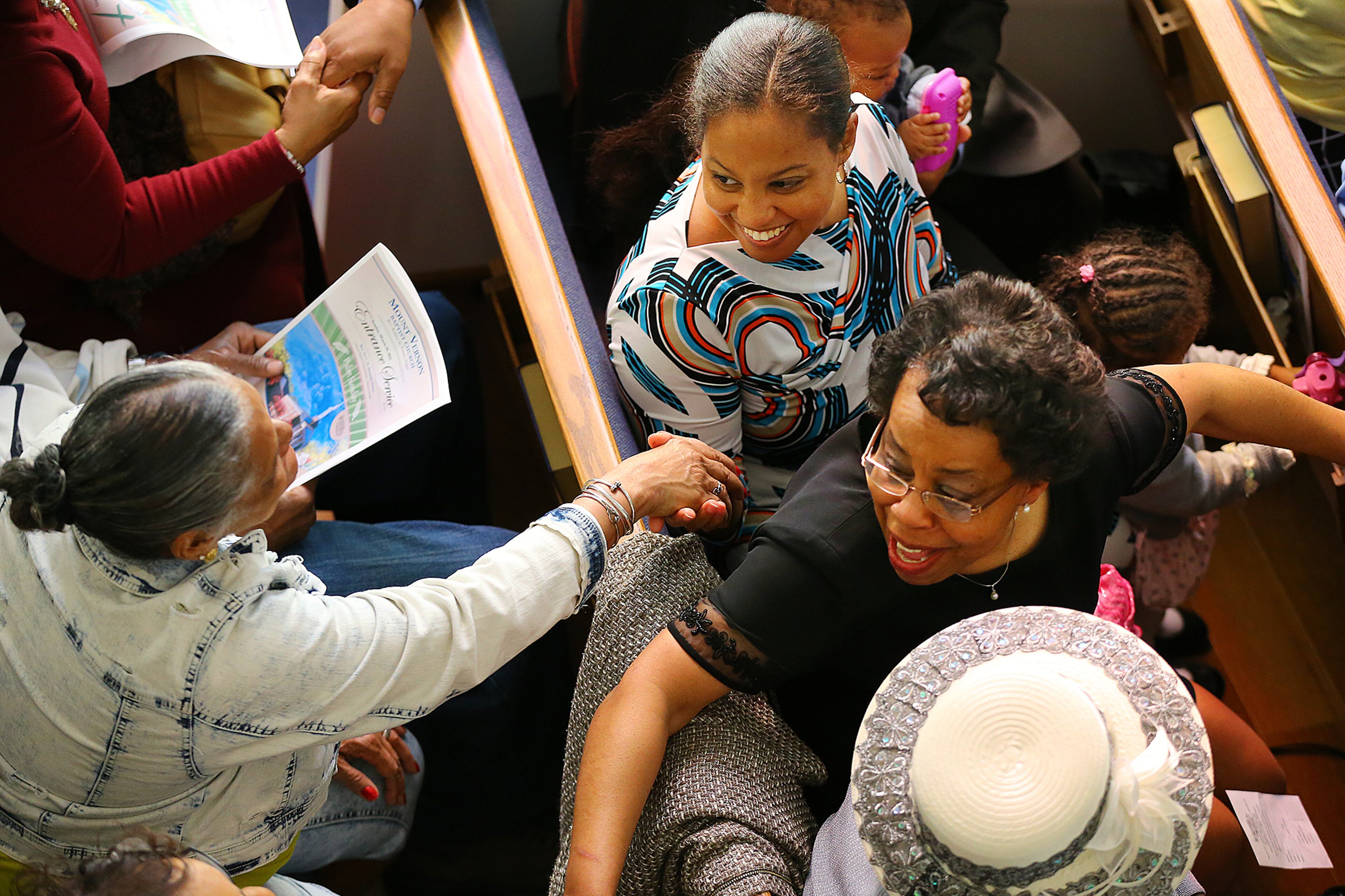 Church members greet one another during the Entrance Service at Mount Vernon Baptist Church on Palm Sunday, March 29, 2015, in Atlanta. Curtis Compton / ccompton@ajc.com