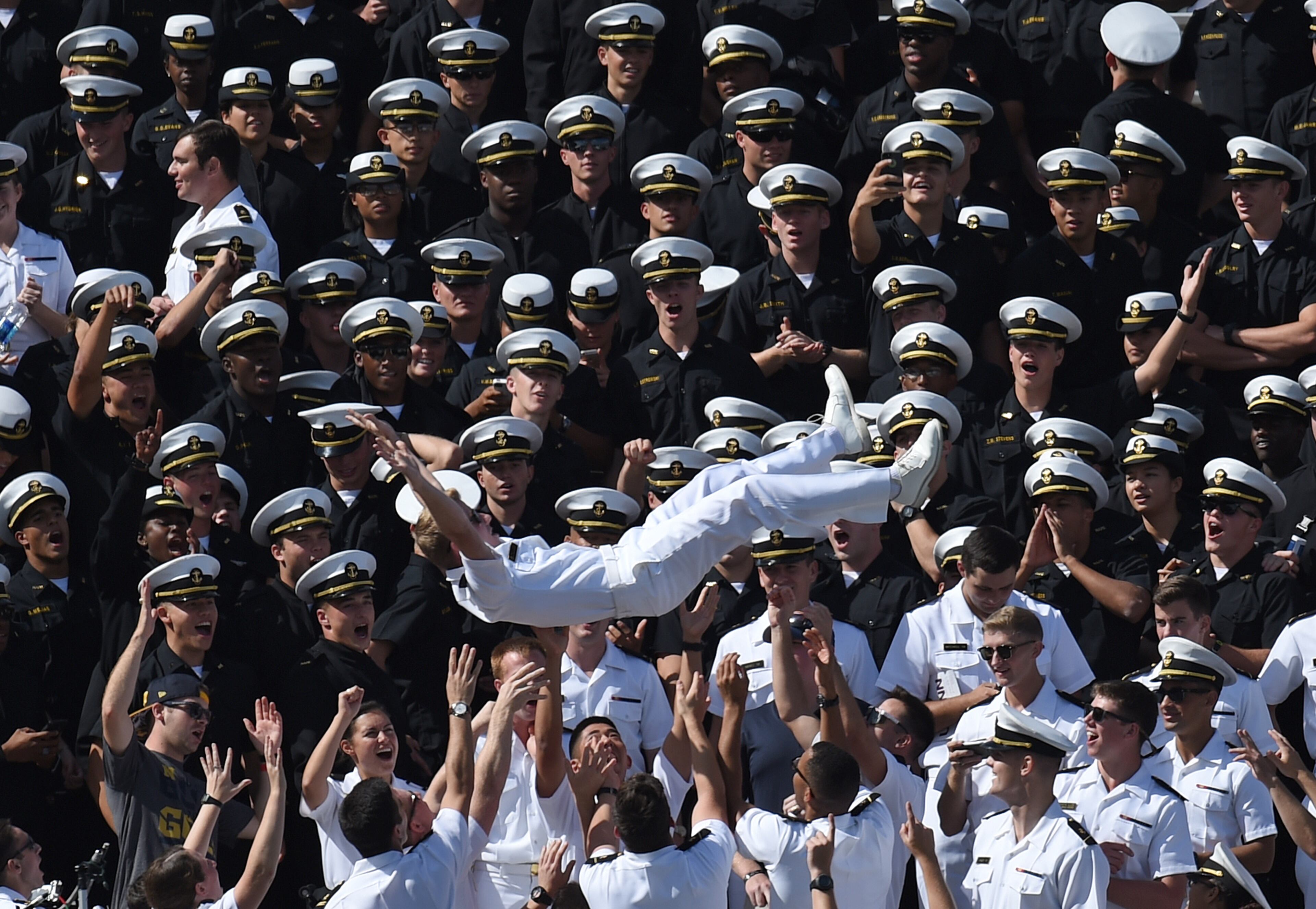 Midshipmen in the stands celebrate during a 28-18 win against Connecticut at Pratt & Whitney Stadium at Rentschler Field in East Hartford, Conn., on Saturday, Sept. 26, 2015. (Brad Horrigan/Hartford Courant/TNS)