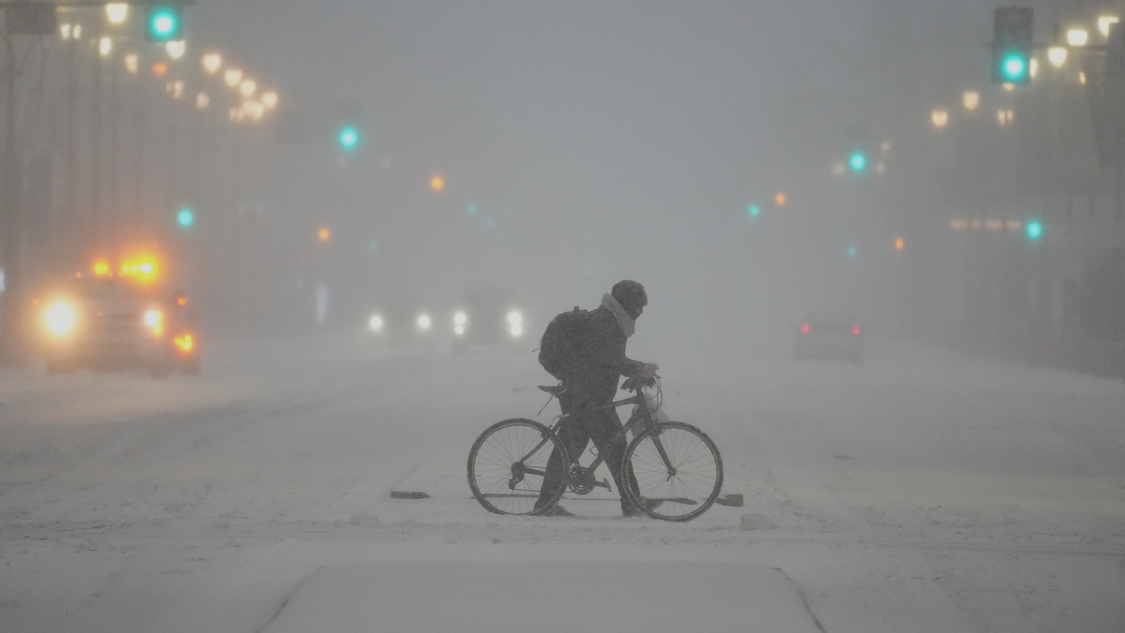 A person pushed a bicycle during a winter storm in Philadelphia, Sunday, Jan. 25, 2026. (AP Photo/Matt Rourke)