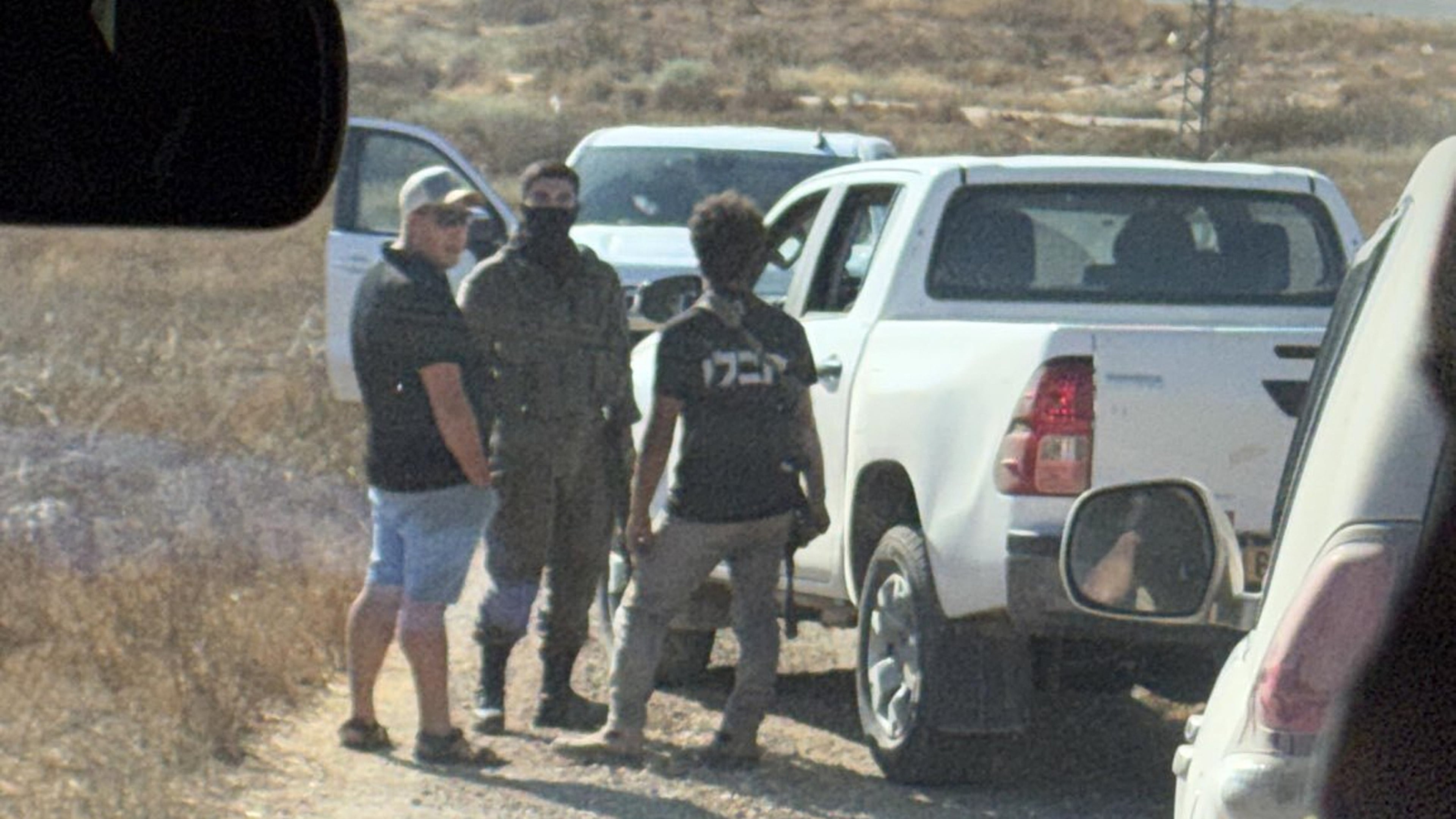 In this photo provided by Cameron Kasky, armed men block the road, stopping vehicles containing U.S. Rep. Ro Khanna, D-Calif., and his delegation near the West Bank village of Khirbet Zanuta, Wednesday, July 8, 2026. (Cameron Kasky via AP)