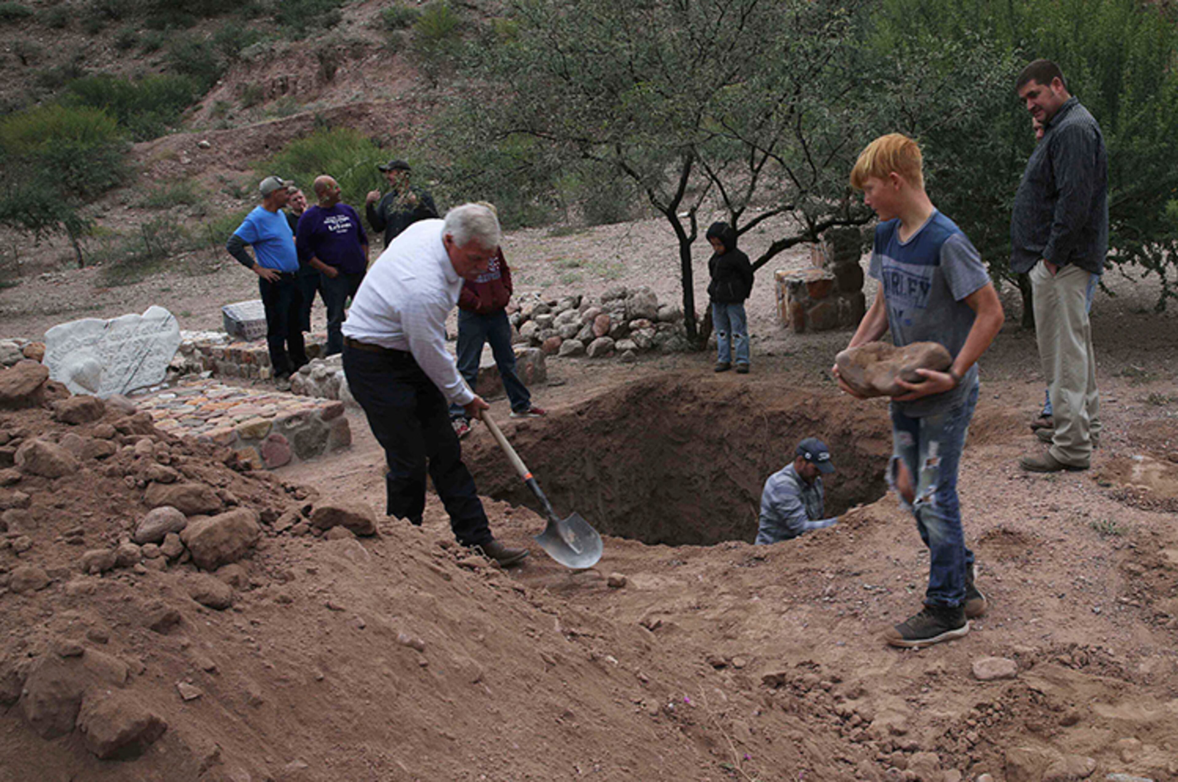 Men dig a mass grave for some of the women and children related to the extended LeBaron family before their burial at a family cemetery in La Mora, Sonora state, Mexico, on Thursday.