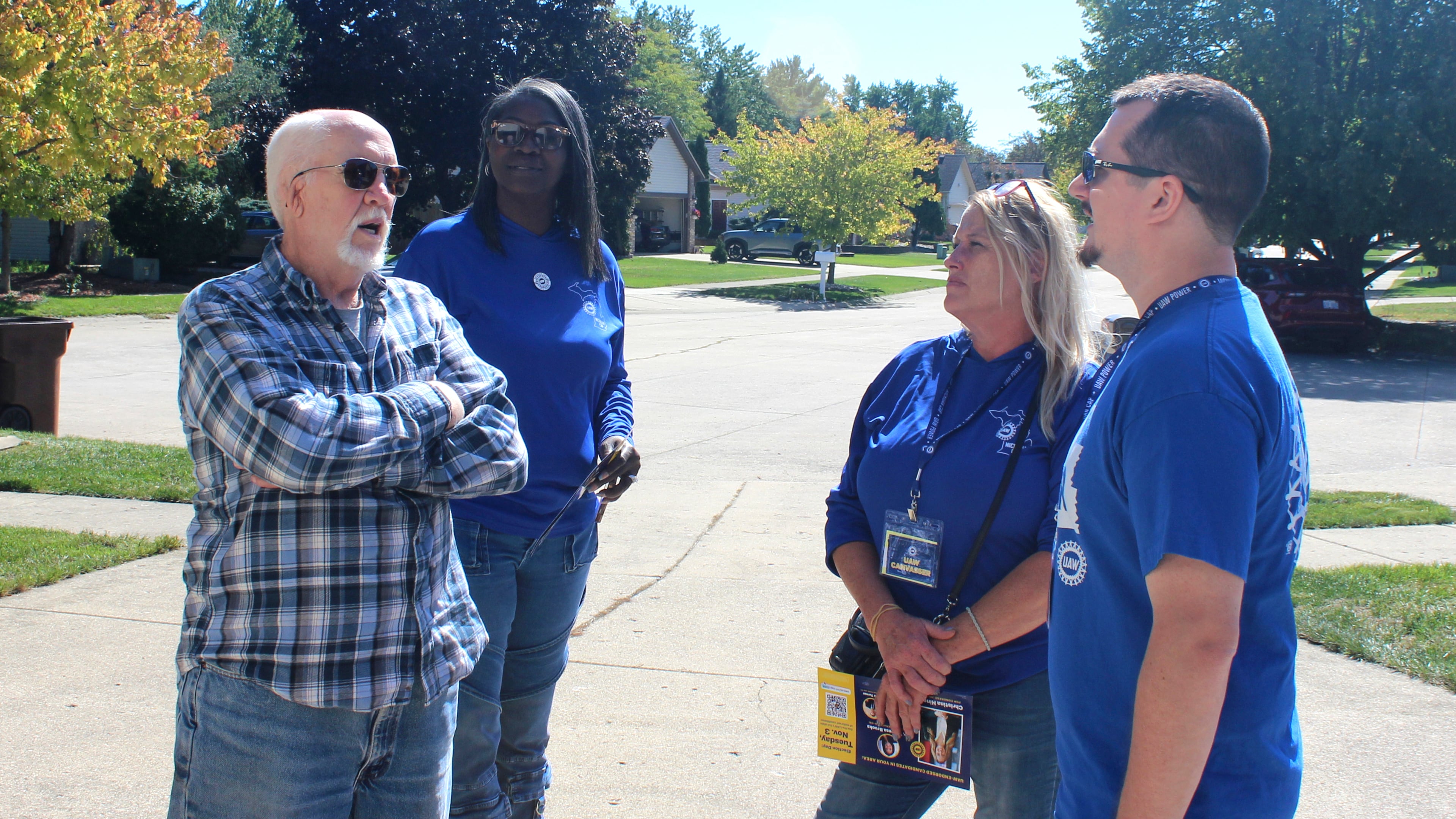 Walter Usakowski, from left, a retired worker from the Ford Motor Co.'s Sterling Axe Plant who plans to vote for the union's slate of Democratic candidates in the midterms, talks with United Auto Workers union canvassers LaShawn Barnett, Kim Avouris and JJ Jewell in Shelby Township, Mich., Saturday, Sept. 26, 2026. (AP Photo/Jacqueline GaNun)