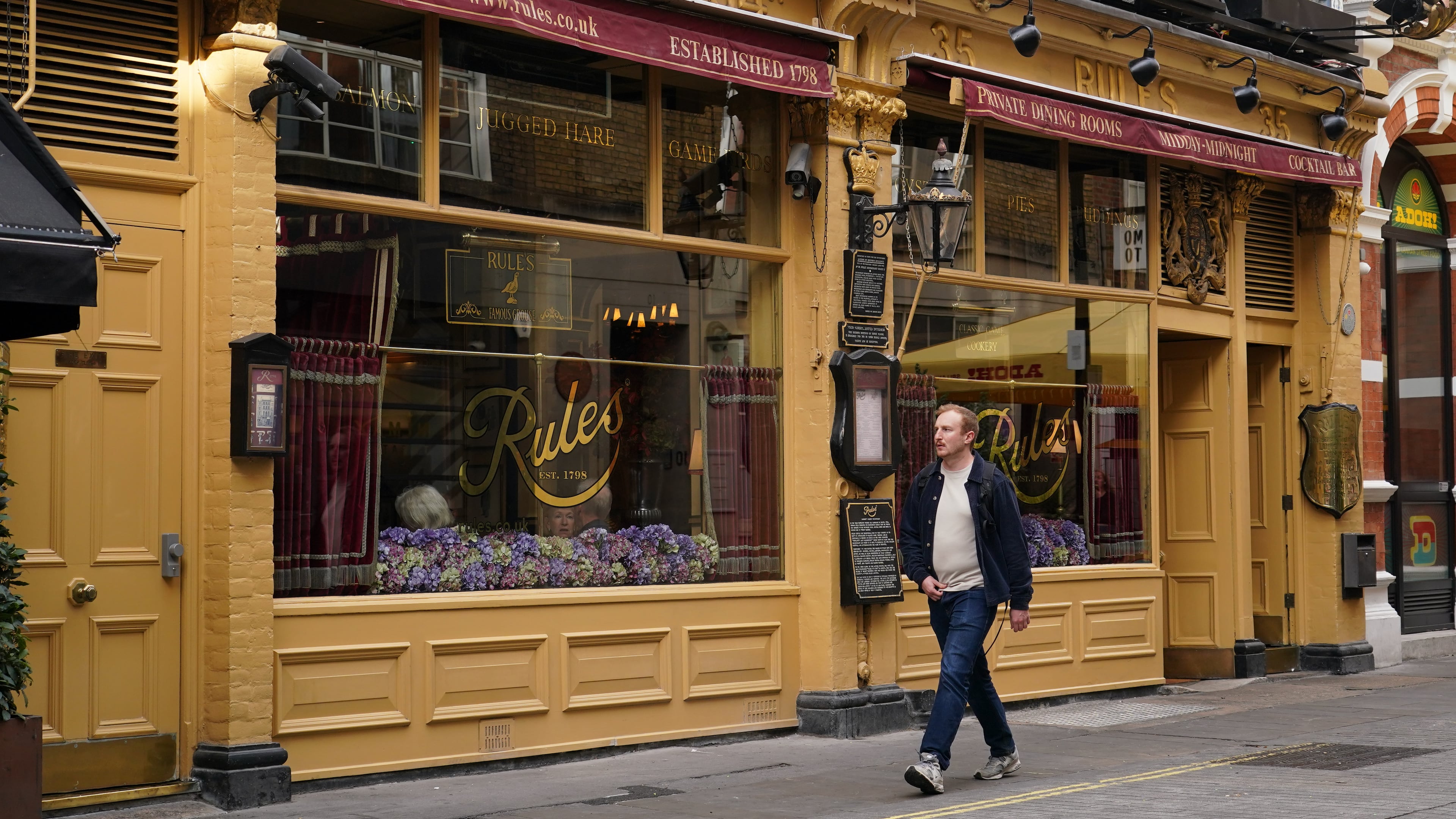 A man walks past London's oldest Restaurant ' Rules' which has been donated to Europe's biggest conservation charity in London, Wednesday, Oct. 14, 2026.(AP Photo/Alberto Pezzali)