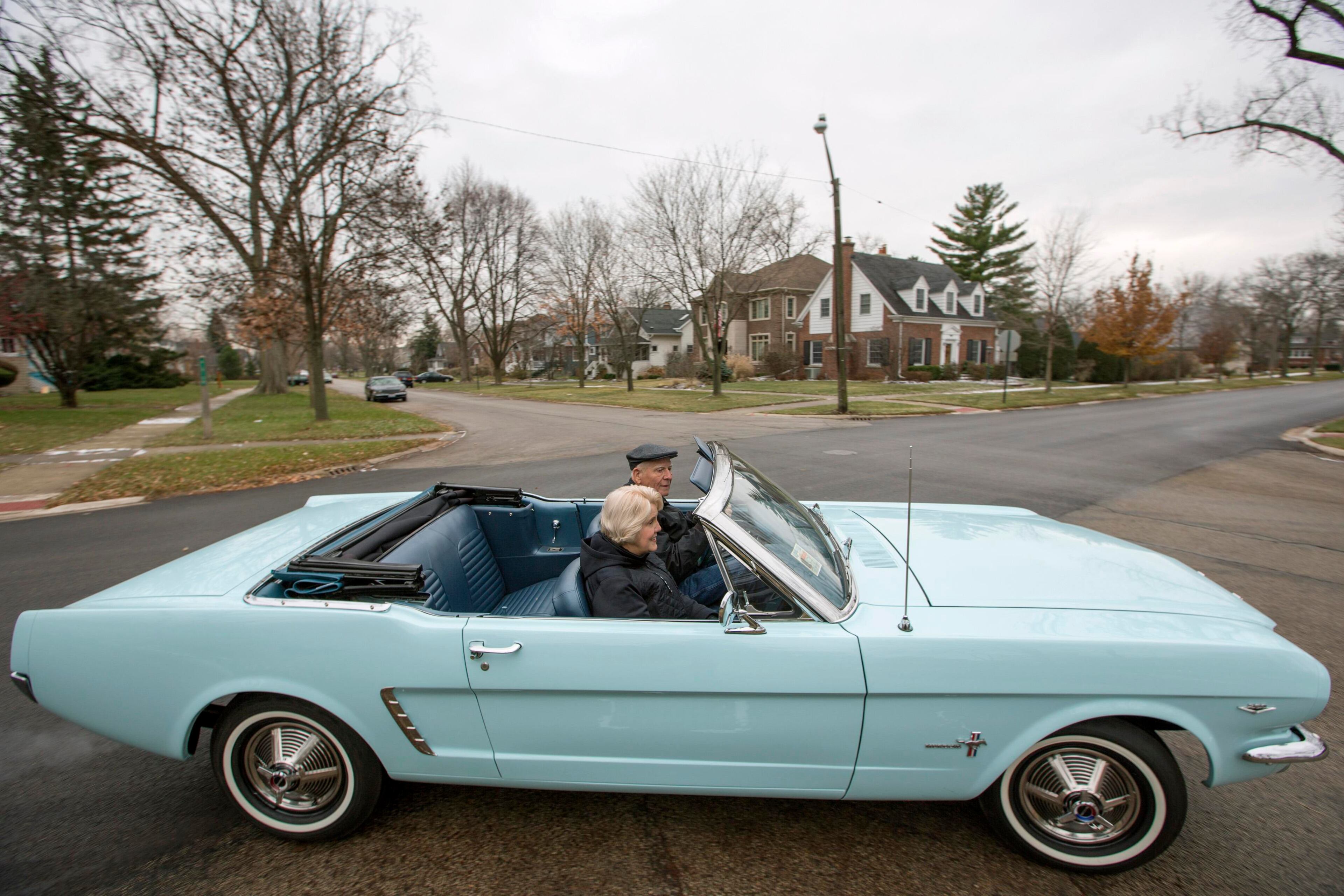 Tom and Gail Wise ride in Gail's Skylight Blue 1964 1/2 Ford Mustang convertible near their home in Park Ridge, Illinois November 26, 2013. Gail Wise, then using her maiden name of Gail Brown, made the first known retail purchase of a Mustang on April 15, 1964, two days before the model went on sale. Ford will unveil its next-generation 2015 Mustang on December 5, 2013 for the model's 50th anniversary with simultaneous events in Michigan, Shanghai, Sydney, Barcelona, New York and Los Angeles. Picture taken November 26, 2013. REUTERS/John Gress