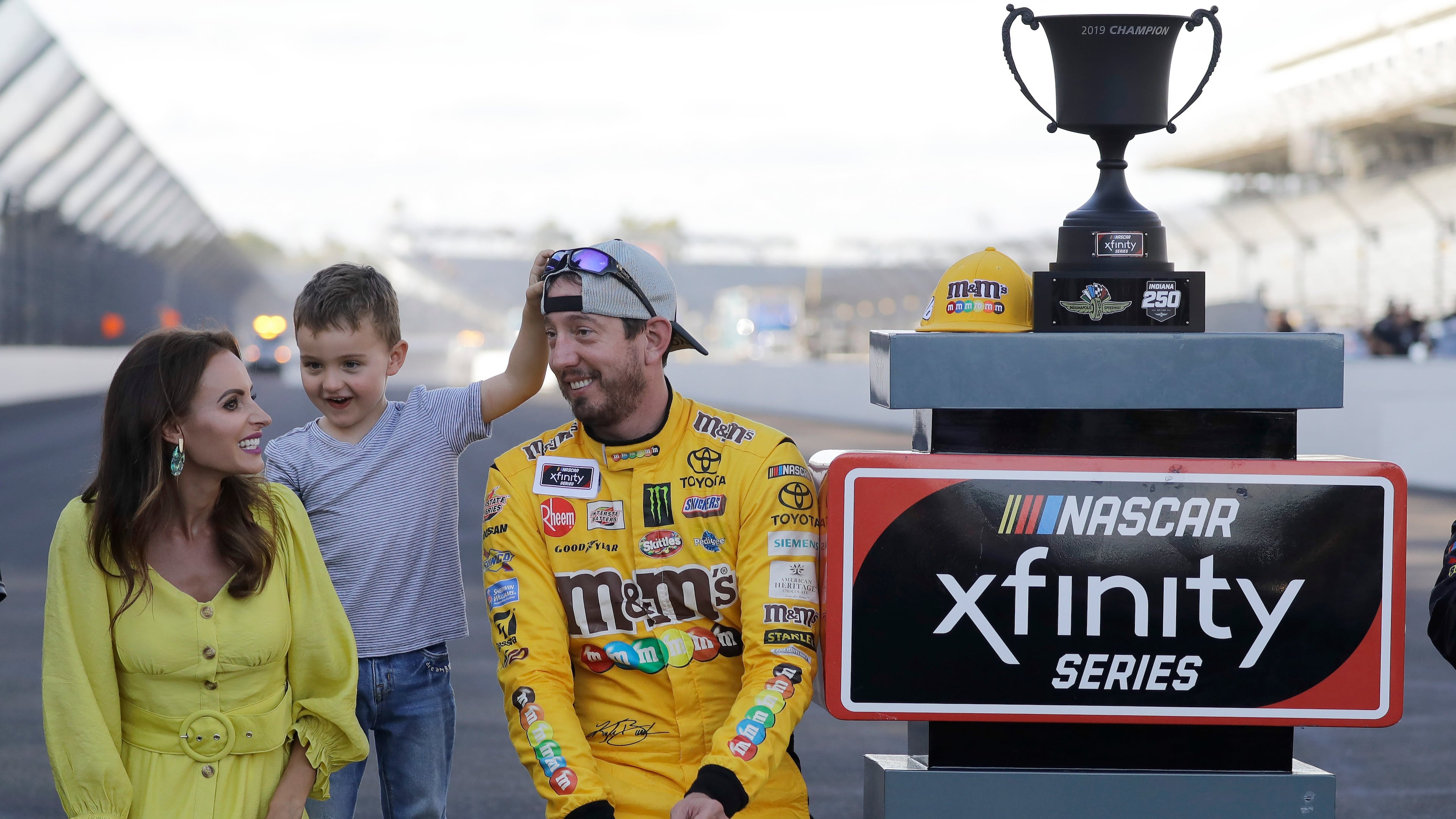 FILE - NASCAR Xfinity Series driver Kyle Busch celebrates with his wife, Samantha, and son, Brexton, after winning the NASCAR Xfinity auto race at the Indianapolis Motor Speedway, Sept. 7, 2019 in Indianapolis. (AP Photo/Darron Cummings, File)