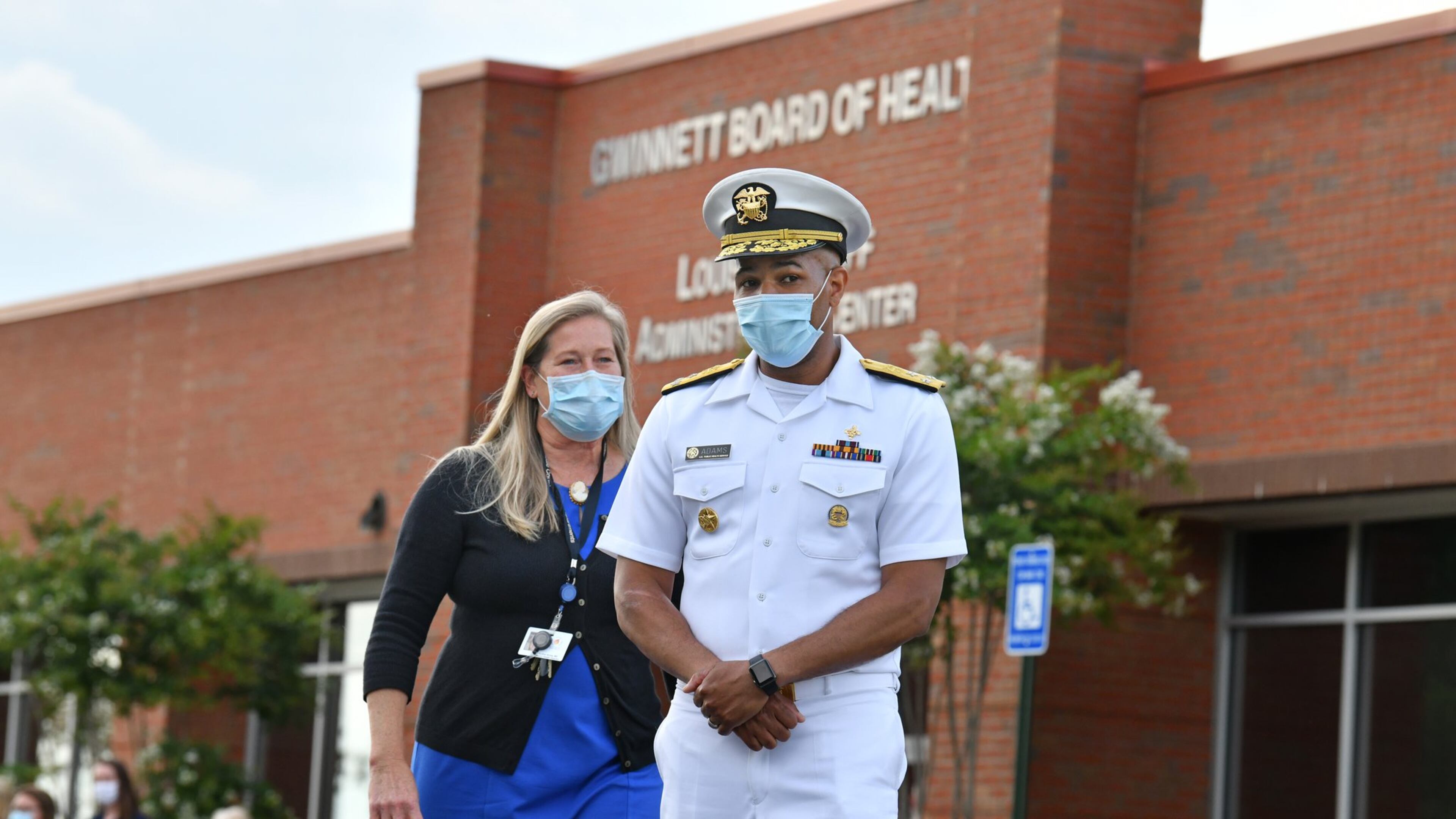 July 2, 2020 Lawrenceville - U.S. Surgeon General Jerome Adams (right) and Gwinnett Newton Rockdale Health Director Audrey Arona walk to the podium for a press conference amid a rise in coronavirus cases in Gwinnett County outside the Louise Radloff Administrative Building in Lawrenceville on Thursday, July 2, 2020. U.S. (Hyosub Shin / Hyosub.Shin@ajc.com)