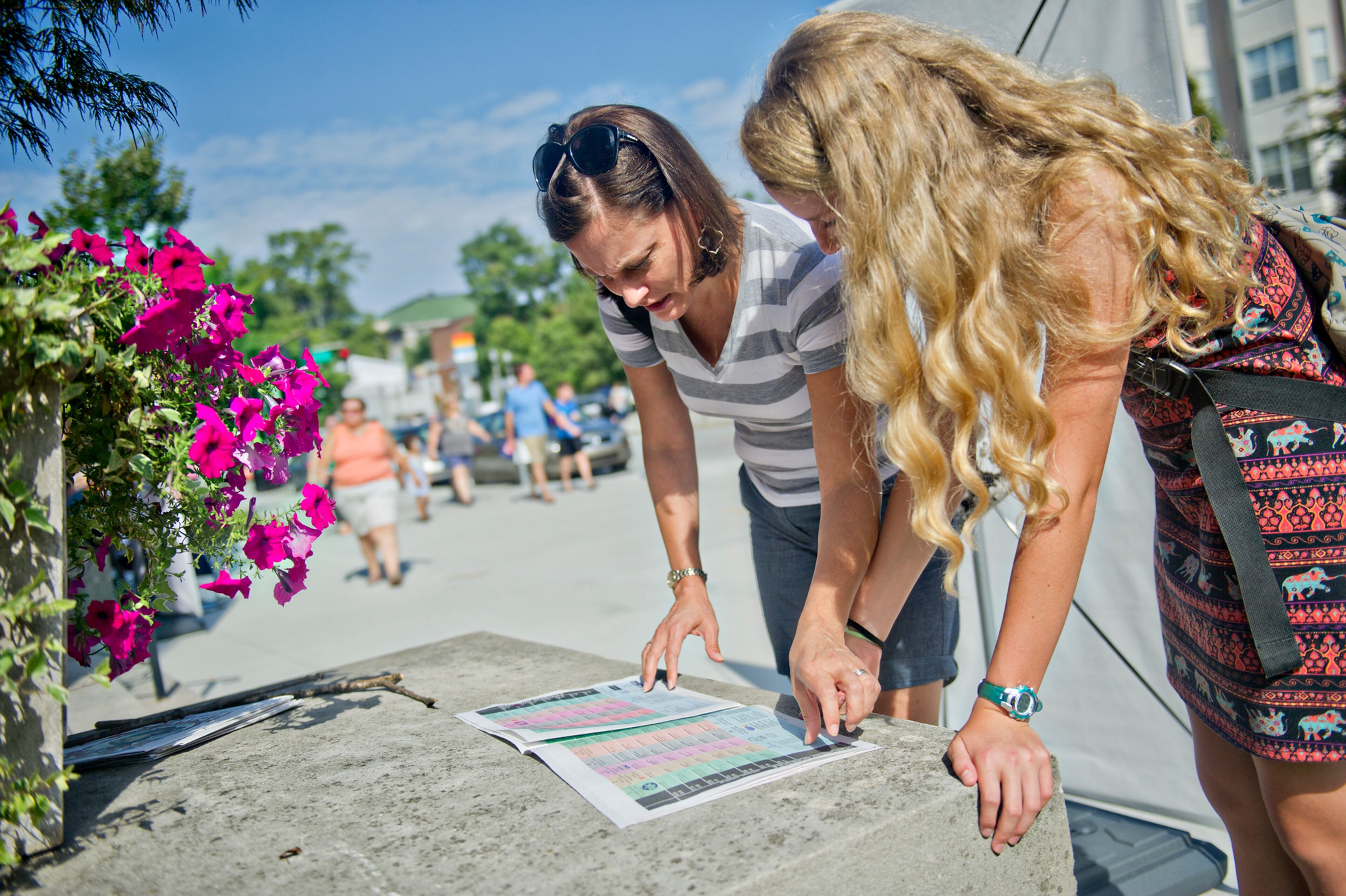 Catherine Brehm (left) and her daughter Margaret look at a schedule as they plan their next stop during the AJC Decatur Book Festival on Saturday, August 30, 2014. The ninth annual event saw tens of thousands of people come out to the downtown Decatur area to meet with world-class authors, illustrators, editors, publishers, booksellers, and artists for a weekend filled with literature, music, food, art, and fun.