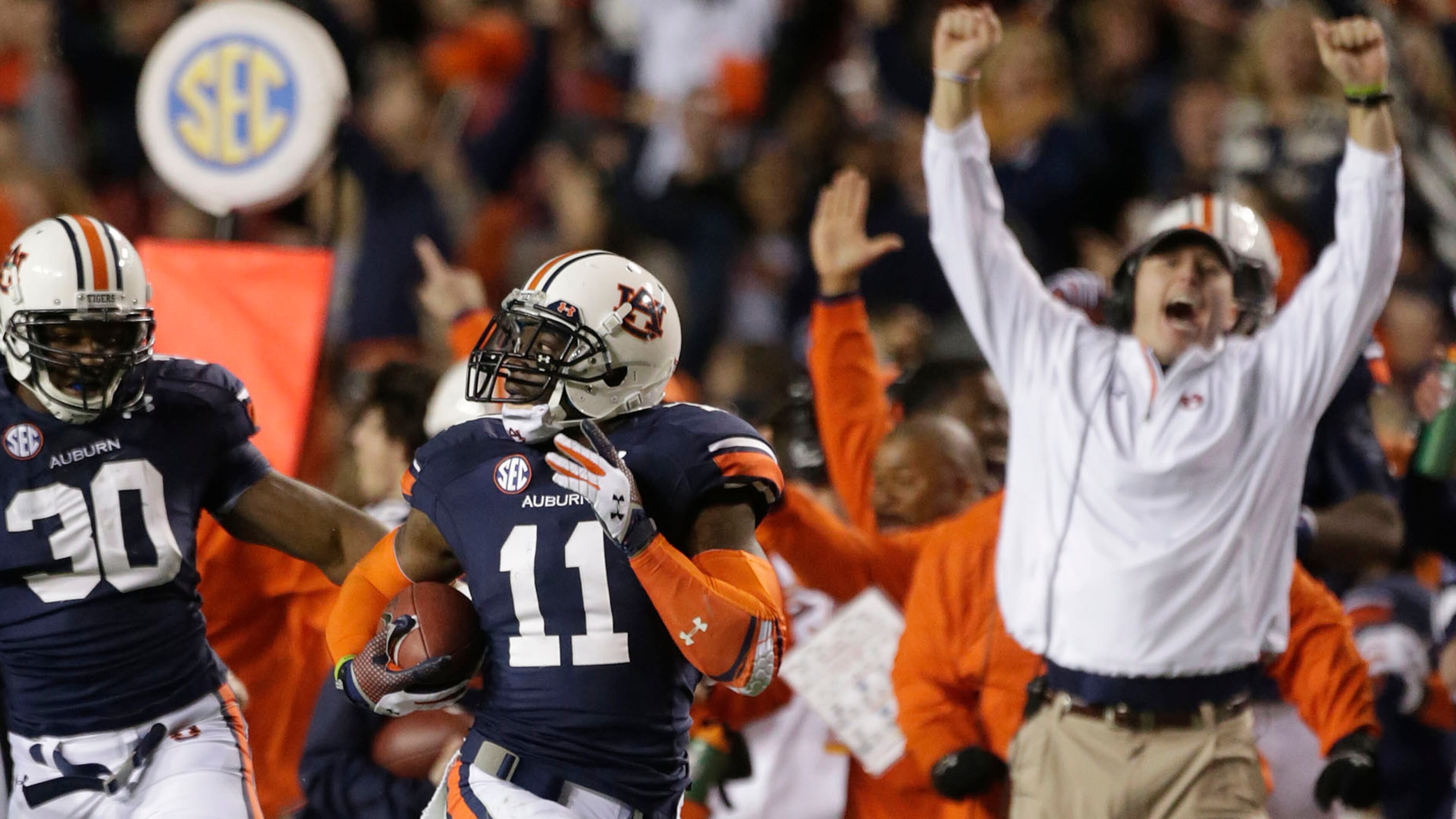 Auburn cornerback Chris Davis (11) returns a missed field goal attempt 100-plus yards to score the game-winning touchdown as time expired in the fourth quarter of an NCAA college football game against No. 1 Alabama in Auburn, Ala., Saturday, Nov. 30, 2013. Auburn won 34-28. (AP Photo/Dave Martin)