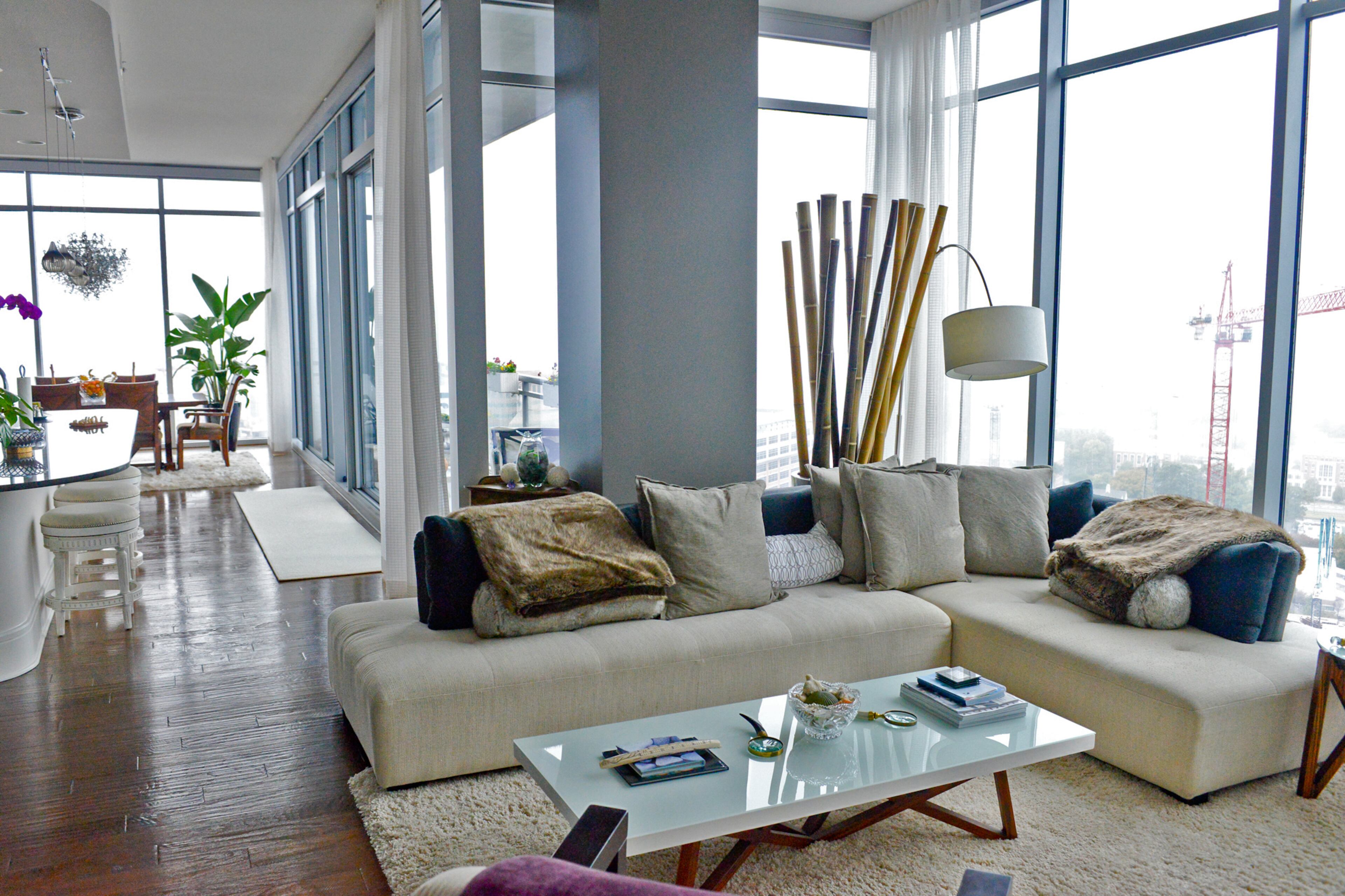 Tall stalks of bamboo create a natural focal point against the walls of glass in Jim Wilson's home in 1065 Midtown, an Atlanta high-rise development.