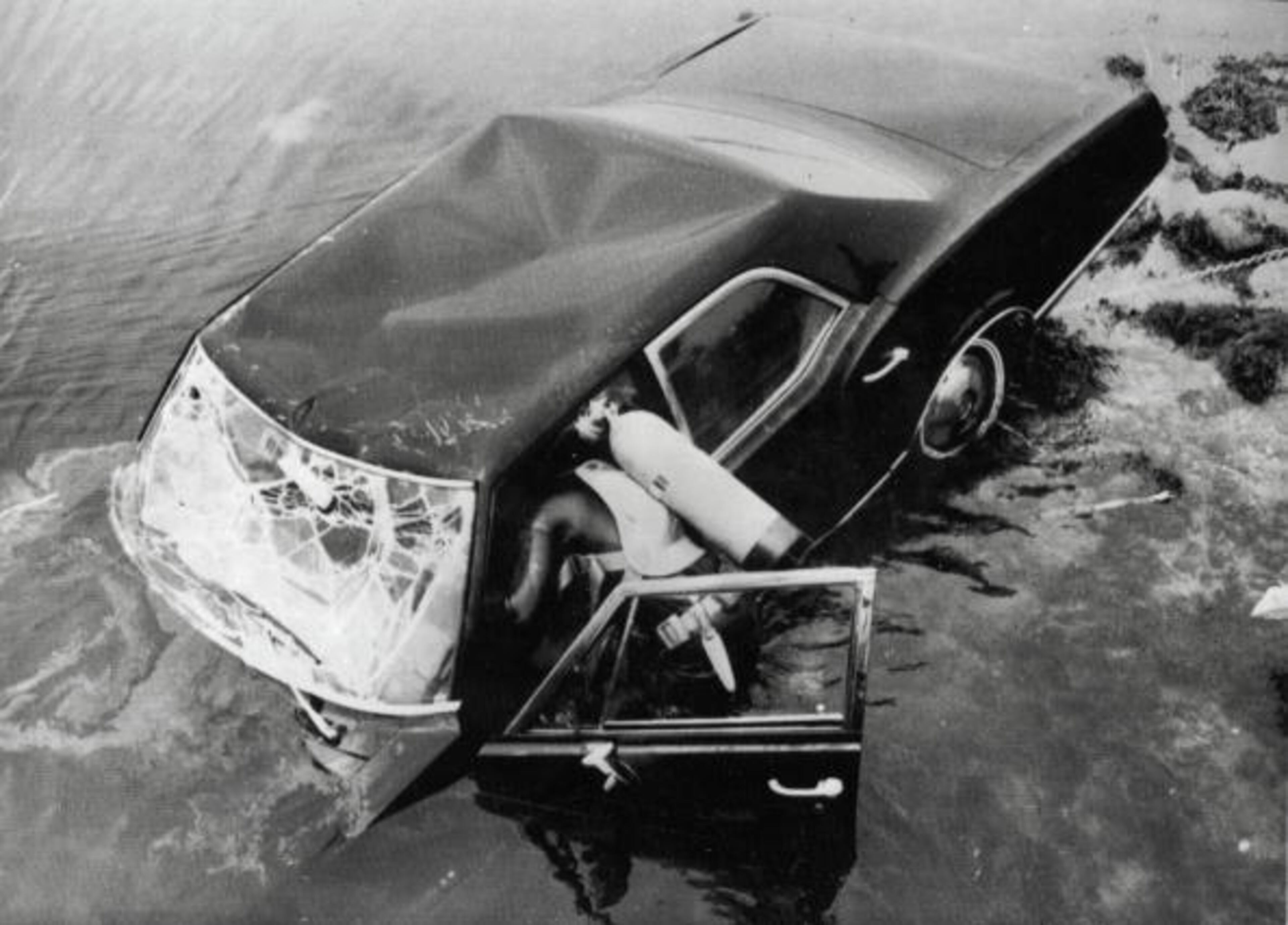 Edgartown, Massachusetts, USA, 19th July, 1969, Frogmen dive into the water as they try to raise the car belonging to Senator Edward Kennedy in which he was seriously injured and his passenger Mary Jo Kopechne was killed, Kennedy pleaded guilty to leaving te secne of the accident at Chappaquiddick Bridge (Photo by Popperfoto/Getty Images)