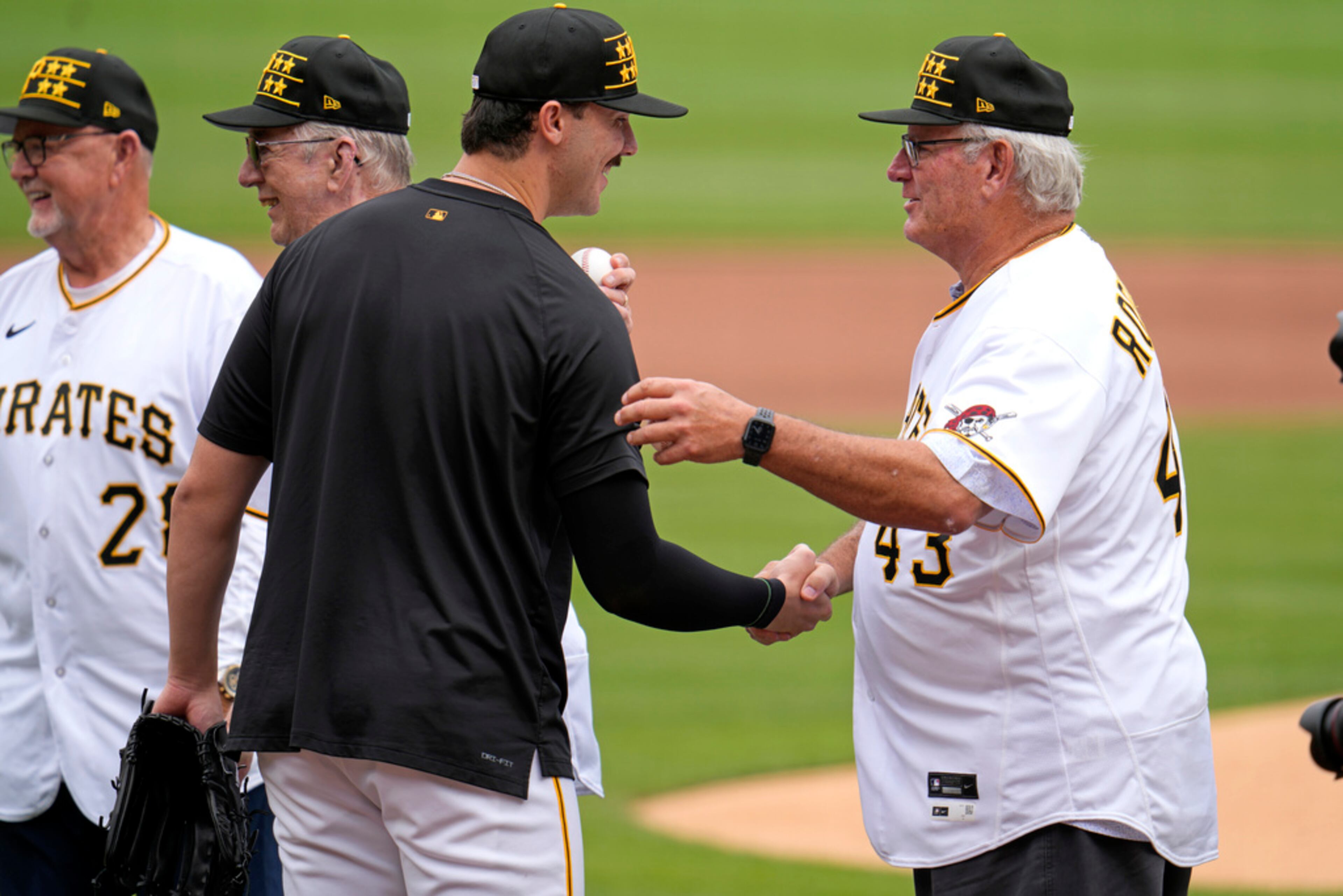 Pittsburgh Pirates pitcher Paul Skenes, center, meets former Pirates pitchers from the 1979 World Series Championship team, left to right, Bert Blyleven, Kent Tekulve, and Don Robinson before a baseball game against the Atlanta Braves in Pittsburgh, Saturday, May 25, 2024. (AP Photo/Gene J. Puskar)
