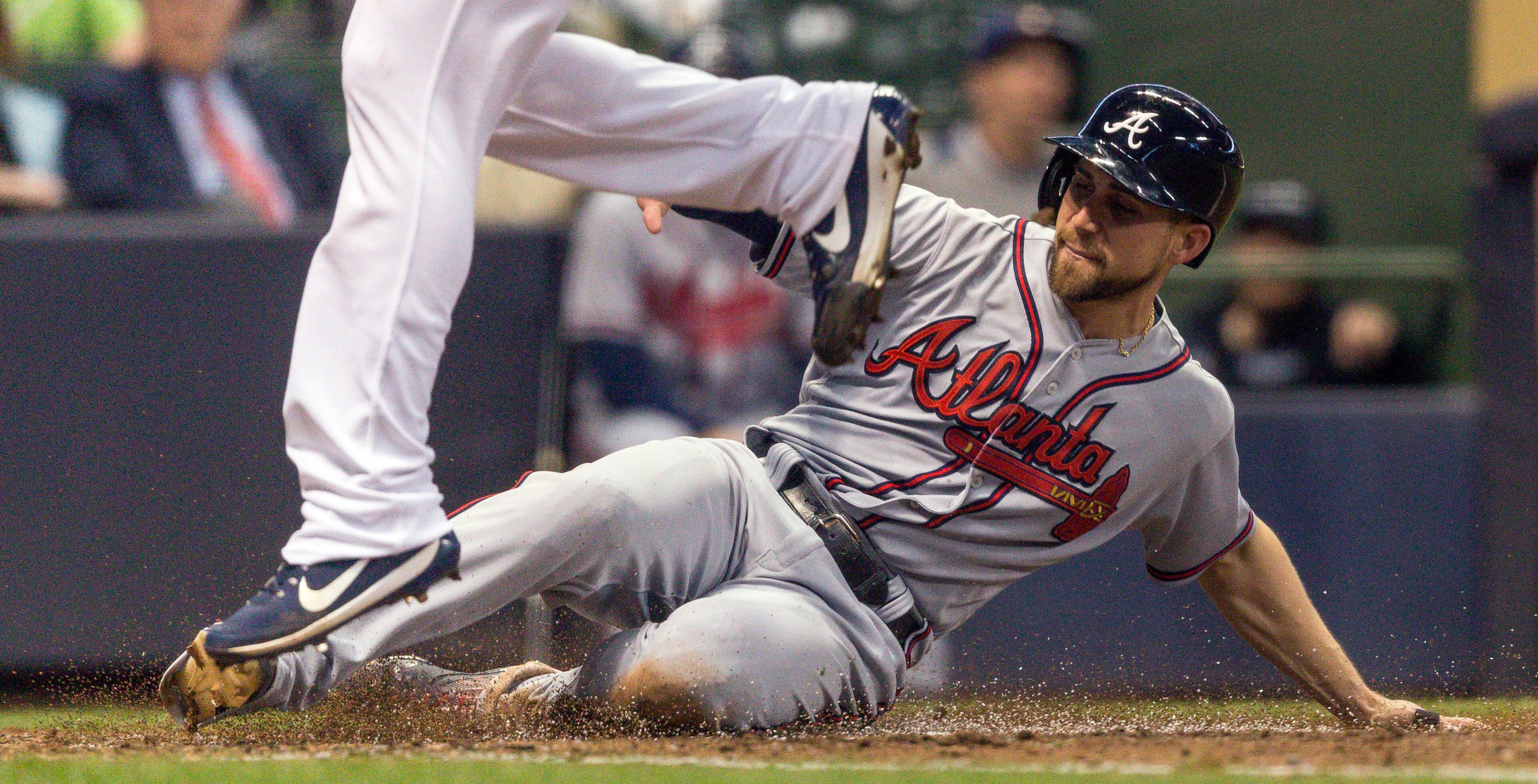 Atlanta Braves' Ender Inciarte scores against Milwaukee Brewers' Manny Pina during the fifth inning of a baseball game Saturday, April 29, 2017, in Milwaukee. (AP Photo/Tom Lynn)