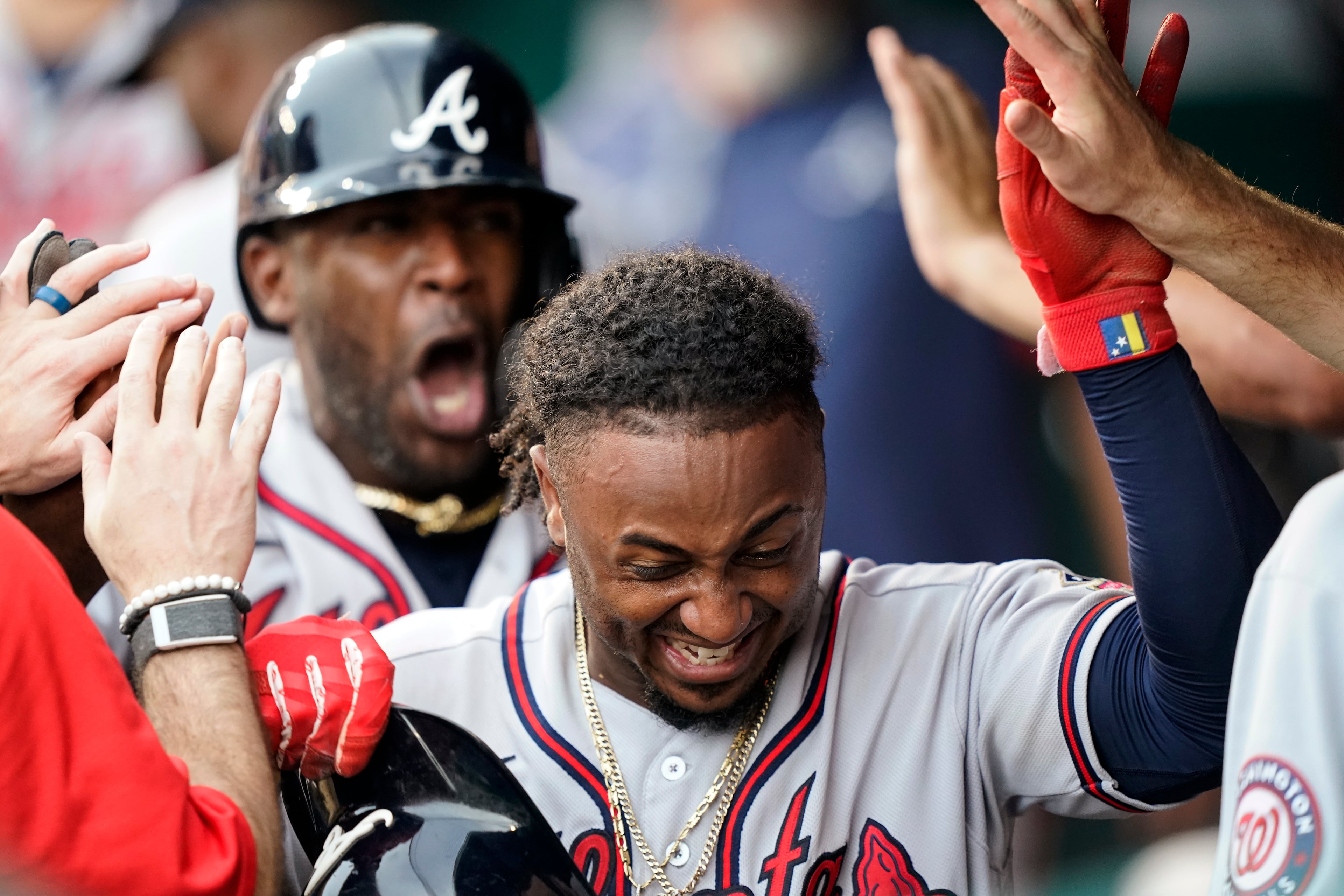 Atlanta Braves' Ozzie Albies is congratulated for his two-run home run during the fifth inning of the team's baseball game against the Washington Nationals at Nationals Park, Saturday, Aug. 14, 2021, in Washington. (AP Photo/Alex Brandon)