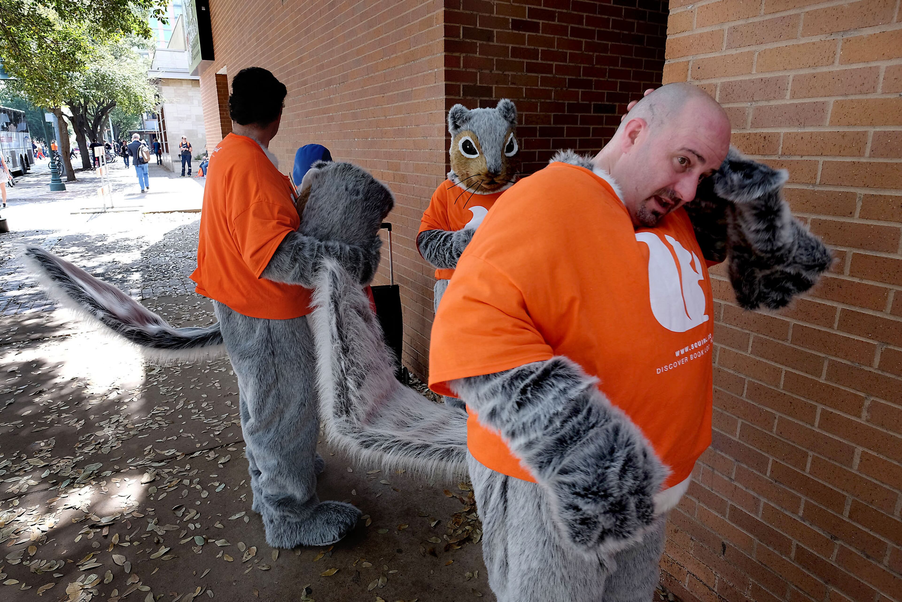 Clint McCreery, right, Alex Kinner, left, and Pat Lokan, center, of Austin, remove their squirrel costume heads to take a break from walking around downtown Austin, Texas, during South by Southwest Interactive on Friday, March 13, 2015. The are three dressed in costume for www.SQUIRL.co, a discovery boook locations app that helps readers find real locations that are written into scenes of books.