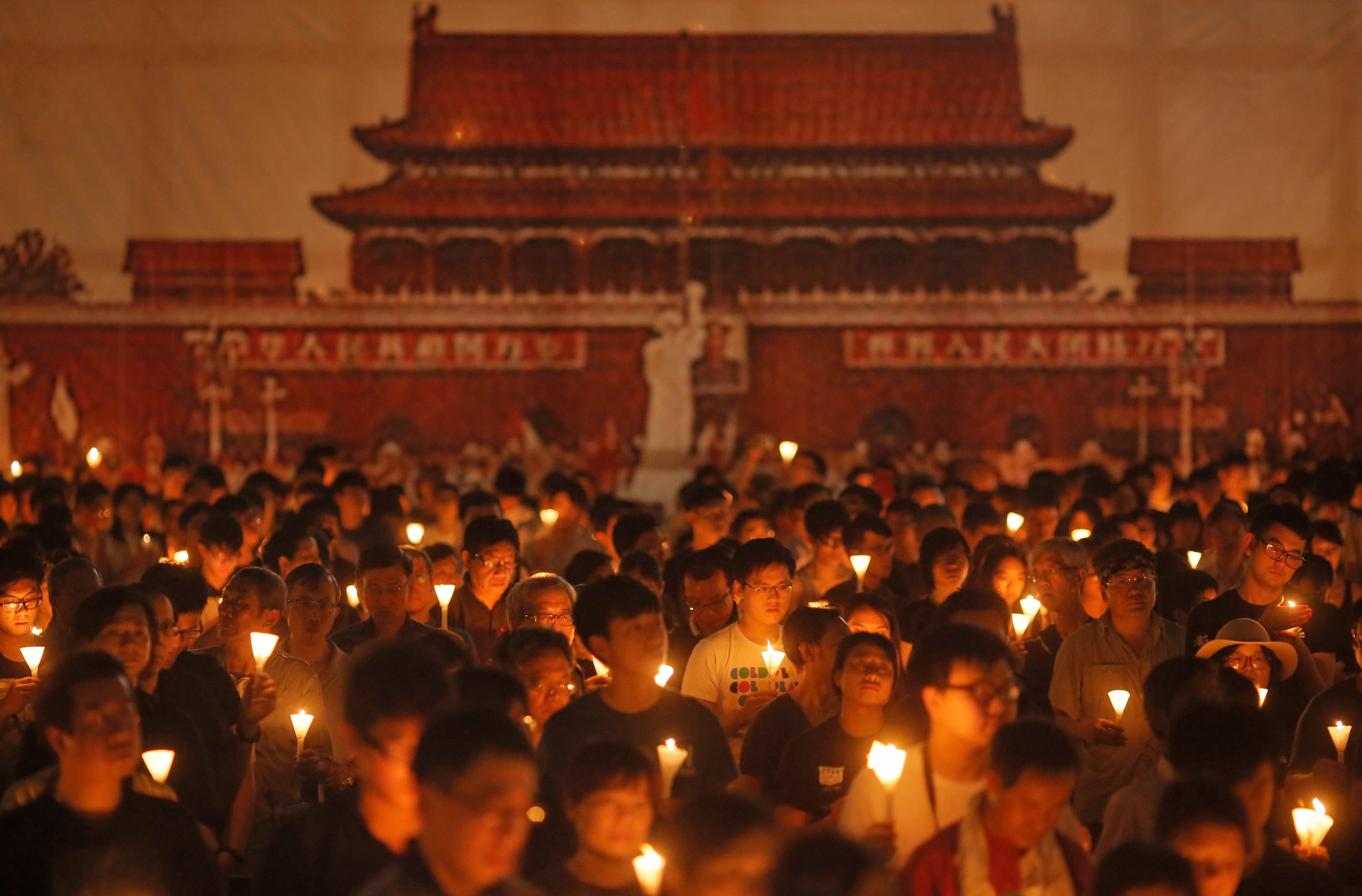 Tens of thousands of people attend a candlelight vigil at Victoria Park in Hong Kong Thursday, June 4, 2015. Tens of thousands of Hong Kongers joined the candlelight vigil Thursday night marking the crushing of the 1989 student-led Tiananmen Square protests, an annual commemoration that takes on greater meaning for the city's young after last autumn's pro-democracy demonstrations sharpened their sense of unease with Beijing. (AP Photo/Vincent Yu)