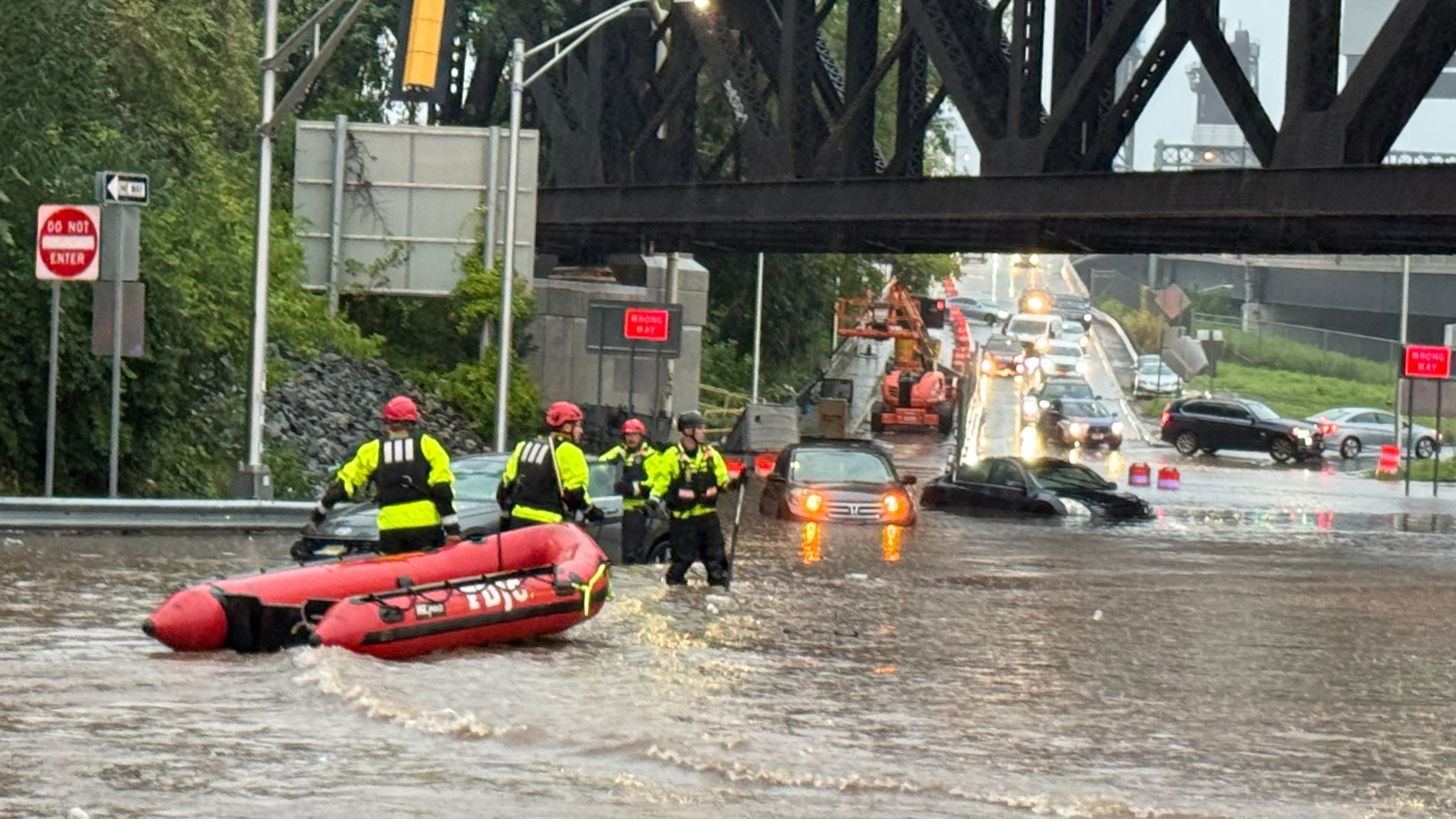In this photo provided by the City of Jersey City, first responders try to rescue people stranded in a flooded street in Jersey City, N.J., Thursday, Aug. 20, 2026, after storms went through the area. (City of Jersey City via AP)