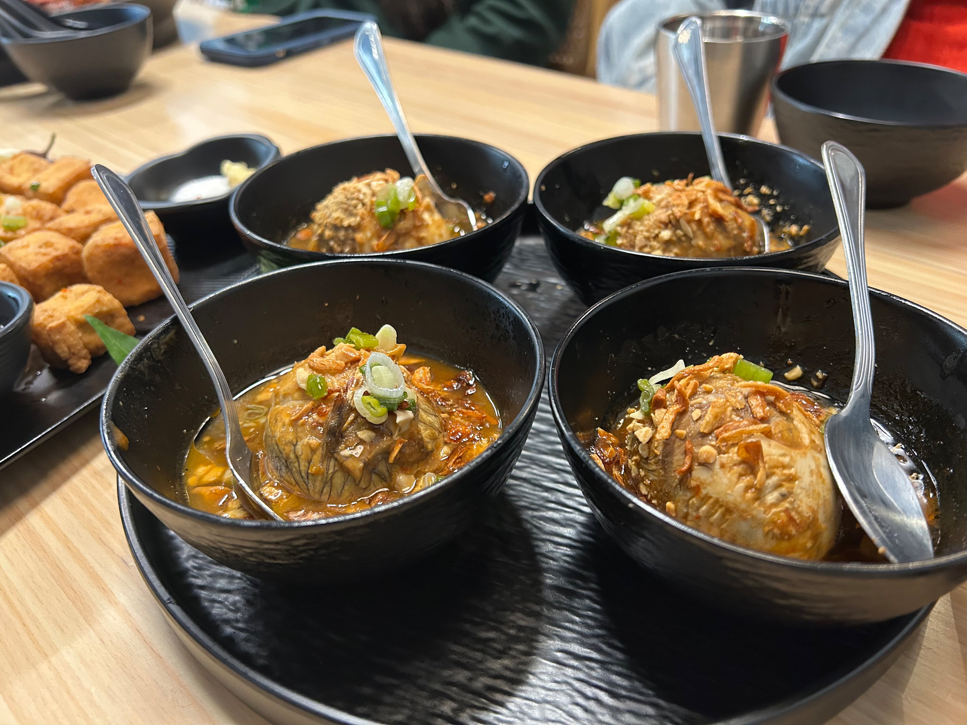 Bowls of hot vit lon xao me, also known as balut or fertilized duck eggs, at Saigon District Kitchen and Bar in Duluth. (Candy Hom for the AJC)