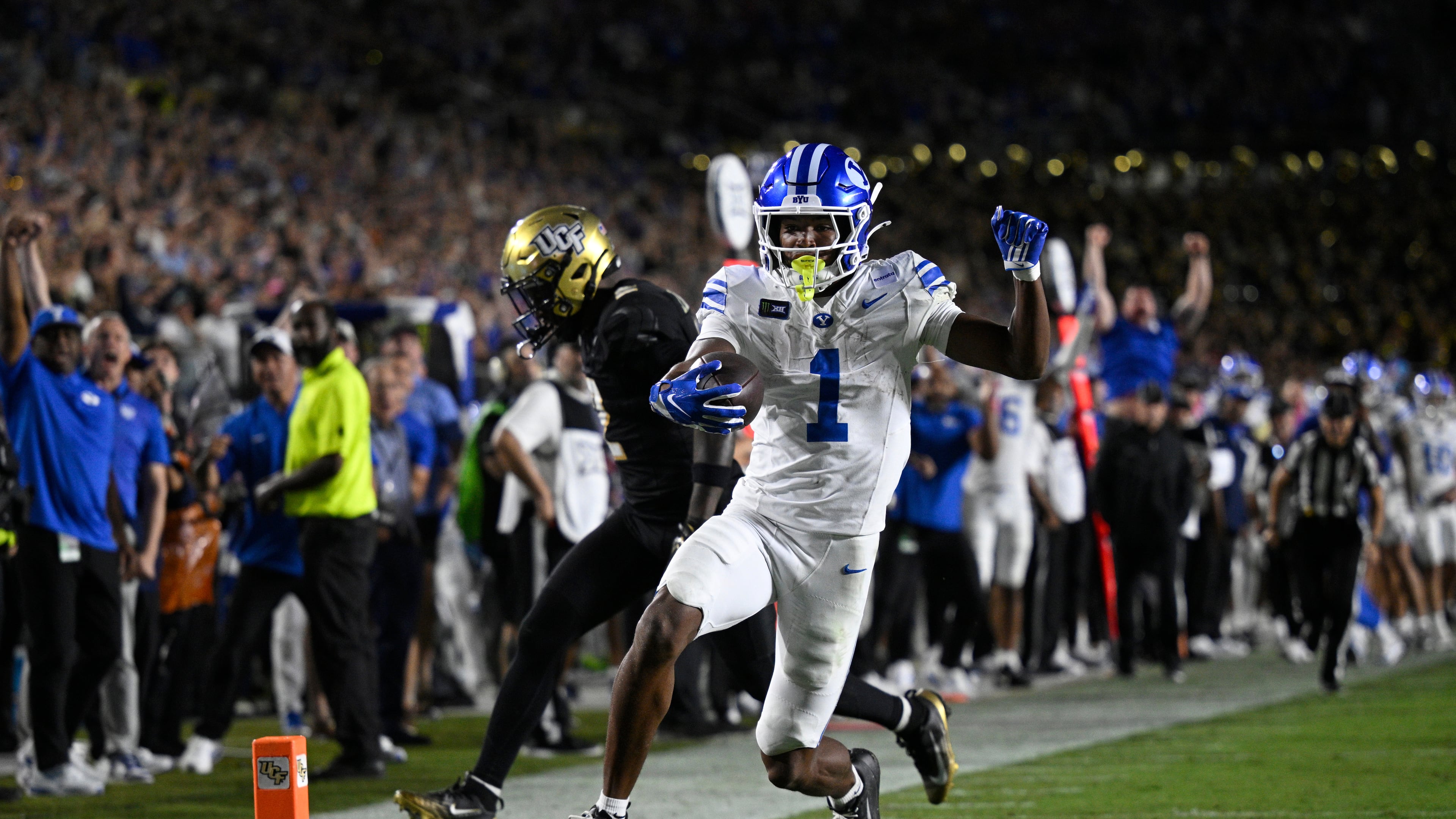 BYU wide receiver Legend Glasker (1) scores a touchdown past Central Florida cornerback Jayden Williams (2) during the first overtime period of an NCAA college football game, Saturday, Oct. 24, 2026, in Orlando, Fla. (AP Photo/Phelan M. Ebenhack)