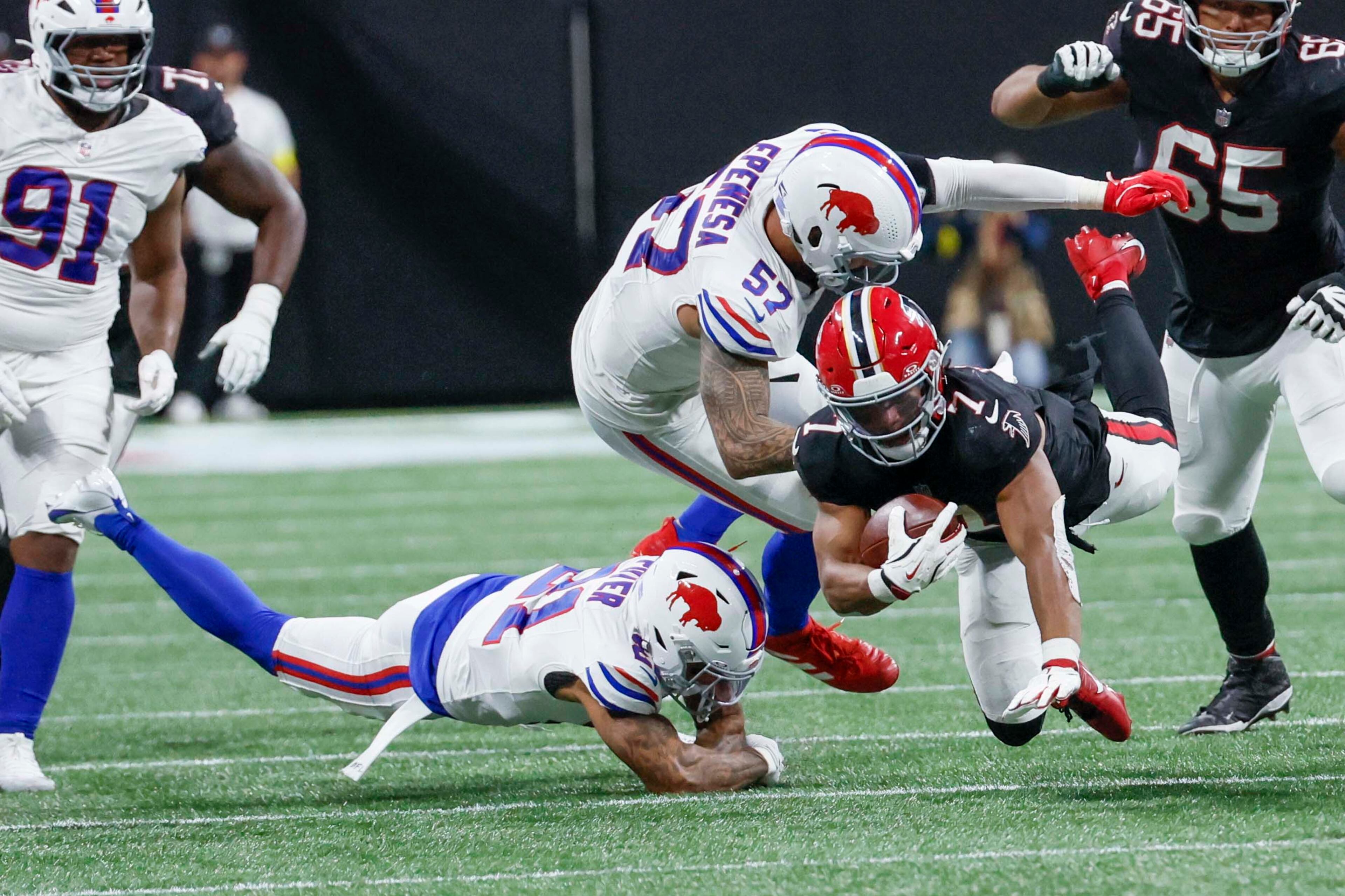 Atlanta Falcons running back Bijan Robinson (7) gets tackled by Buffalo Bills defensive end A.J. Epenesa (57) during the second half of an NFL game at Mercedes-Benz Stadium in Atlanta on Monday, October 13, 2025. (Miguel Martinez/ AJC)