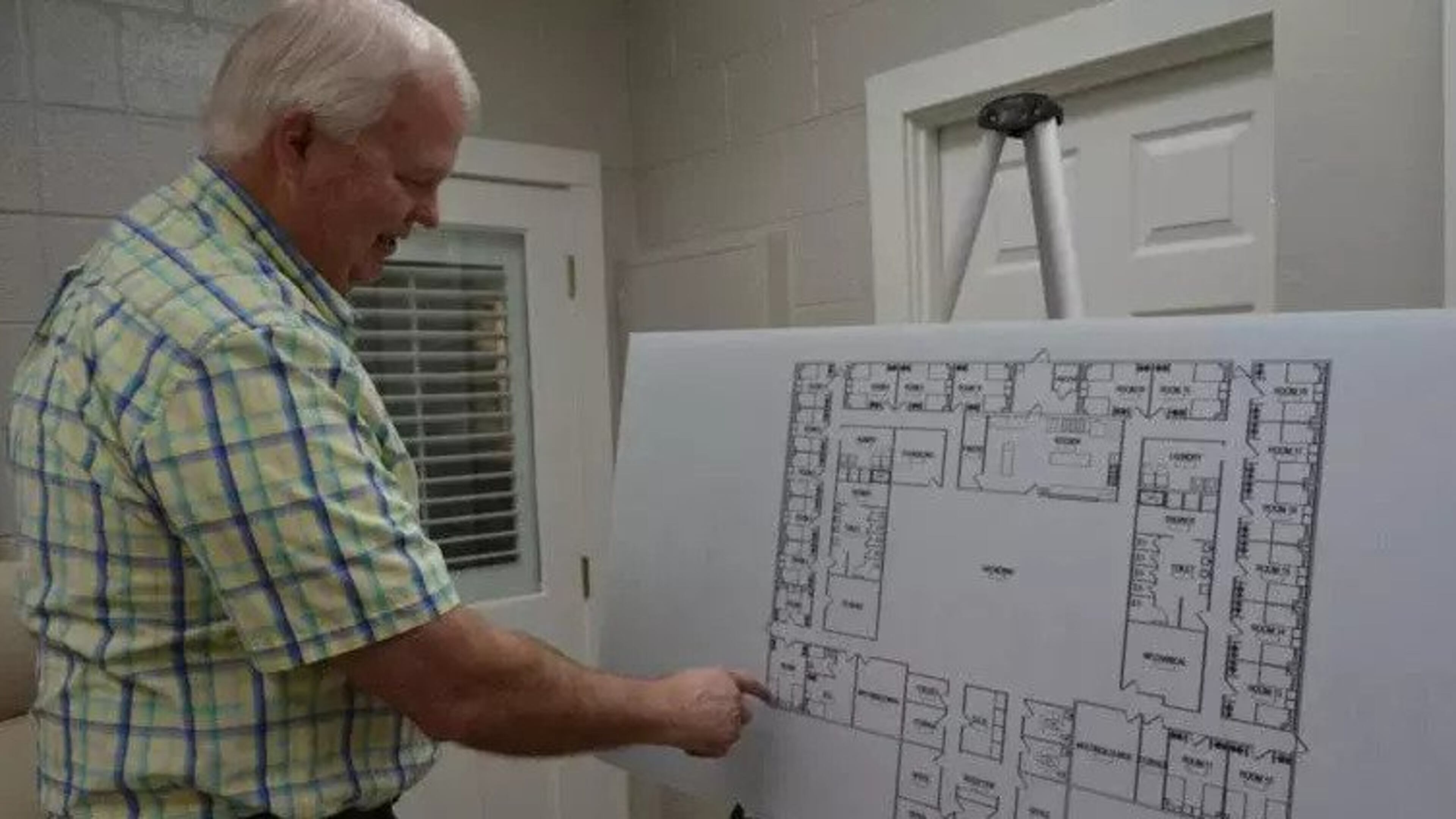 Jeff Neal, a board member with the Anchorage of Albany, gives a rundown of the floor plan for a women’s Anchorage treatment facility. The Anchorage hopes to begin construction early next year. (Photo Courtesy of Alan Mauldin)