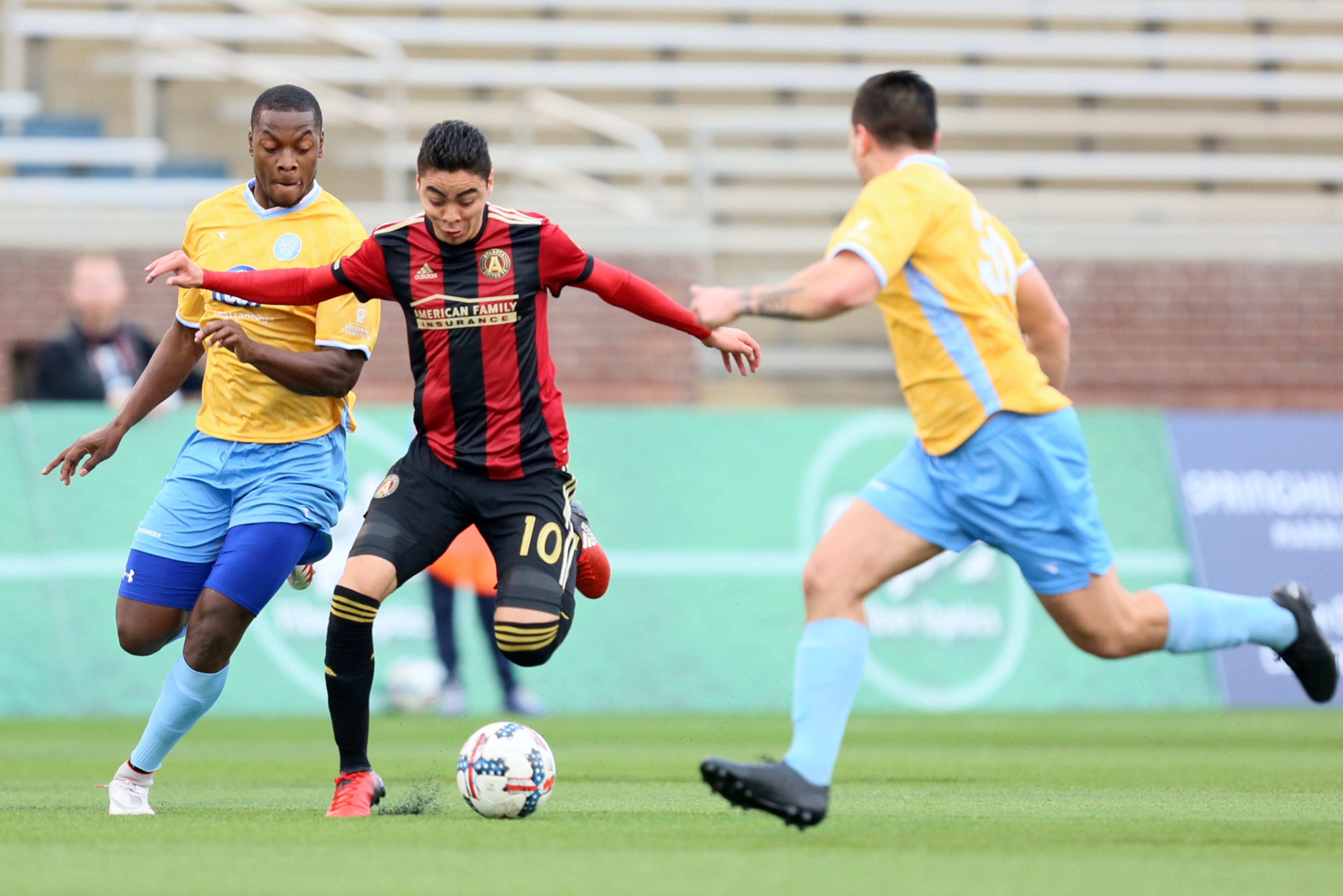 FEBRUARY 11, 2017 CHATTANOOGA TN Midfielder Miguel Almiron (10) dribbles the ball through two defenders.