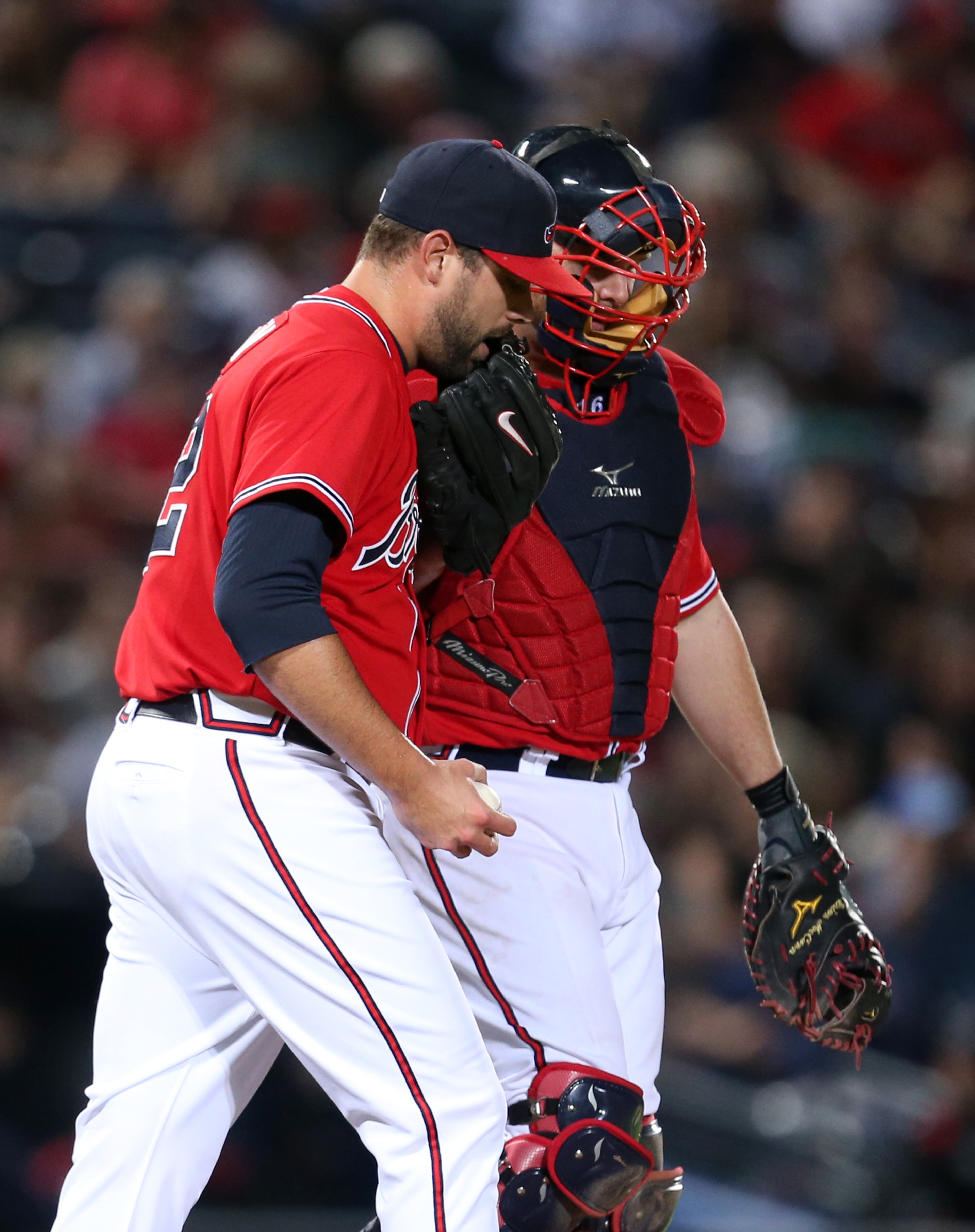Braves catcher Brian McCann, right, talks with reliever Jordan Walden after Walden gave up a solo home run by San Diego Padres Chase Headley to tie the game in the 8th inning of their game at Turner Field Friday night in Atlanta, Ga., September 13, 2013. JASON GETZ / JGETZ@AJC.COM